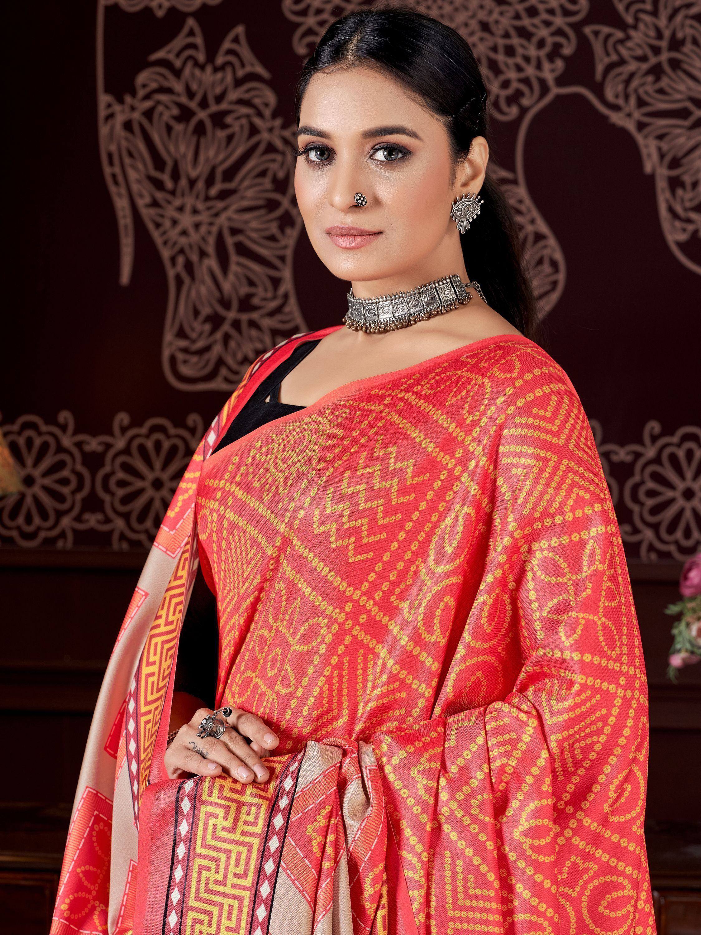 Woman in vibrant red and gold patterned saree with ethnic jewelry, perfect for Indian ethnic wear occasions