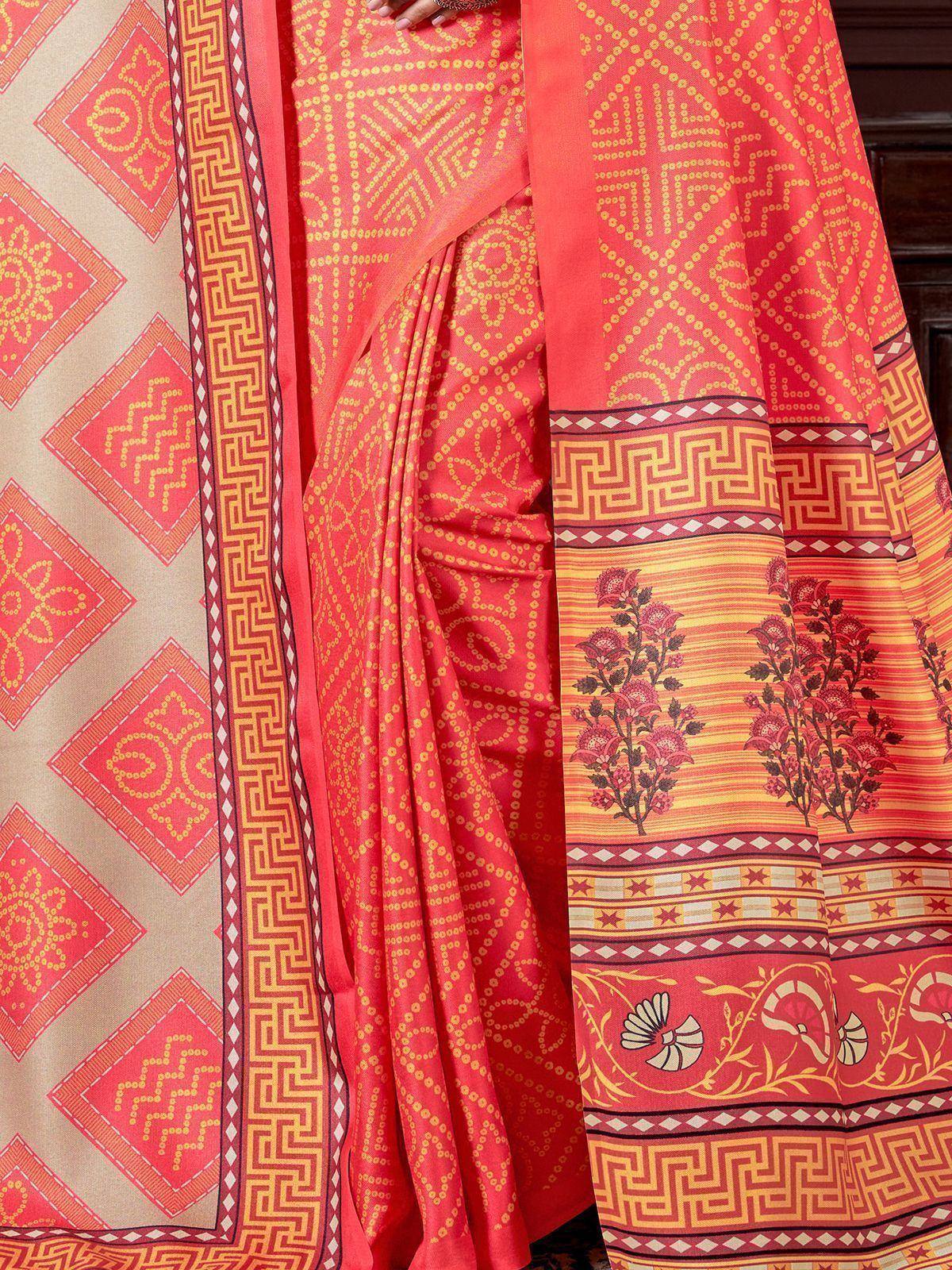 Vibrant coral saree with geometric and floral prints, perfect for ethnic occasions