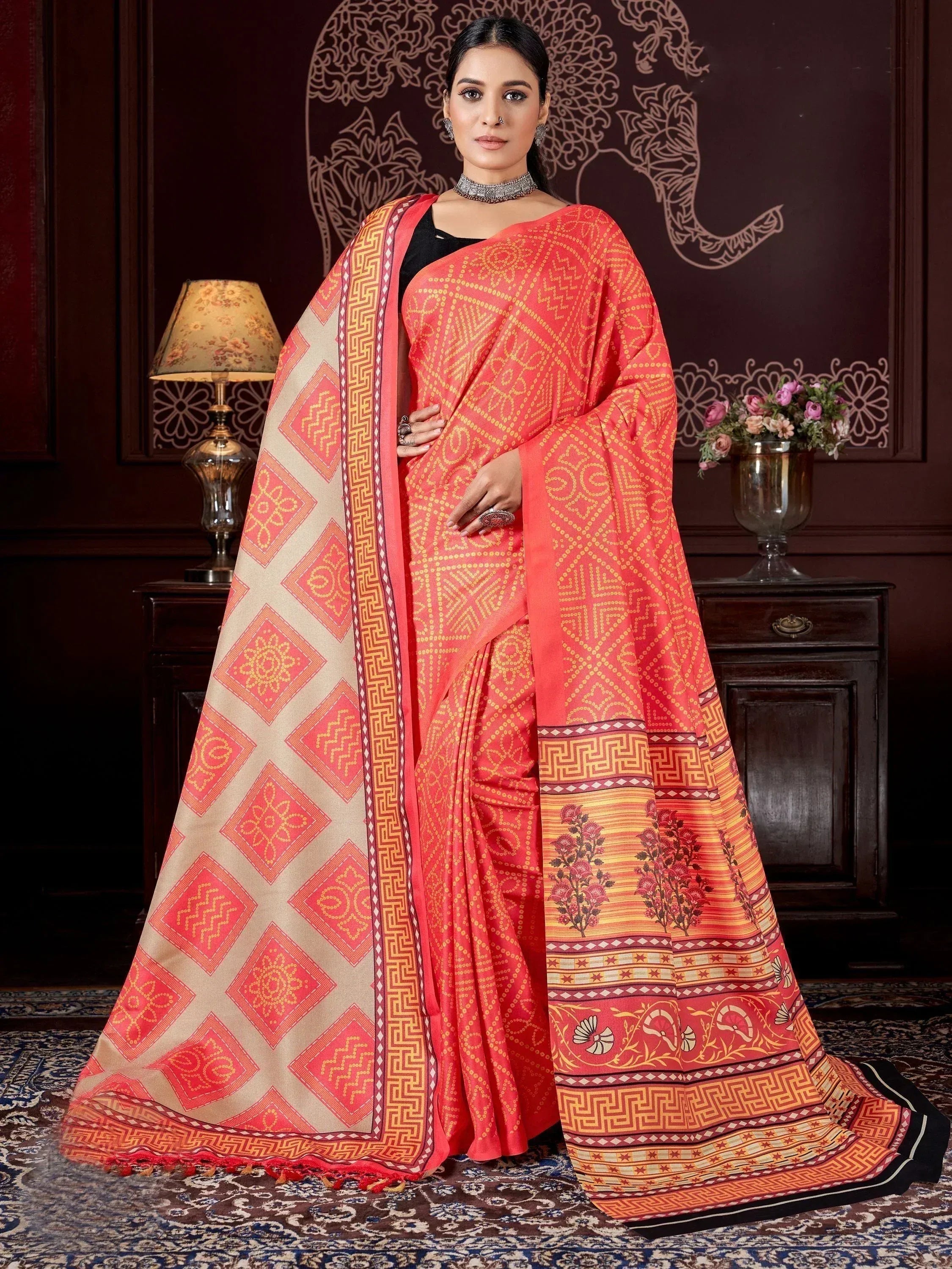 Woman in vibrant coral ethnic saree with geometric and floral print, perfect for Indian occasions