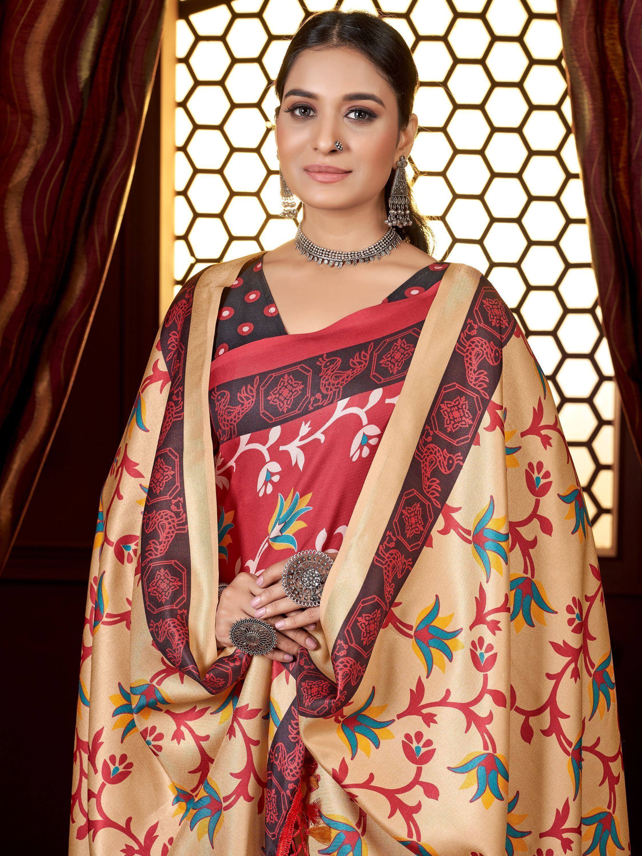 Woman in elegant red and beige printed saree with traditional jewelry, perfect for Indian ethnic occasions