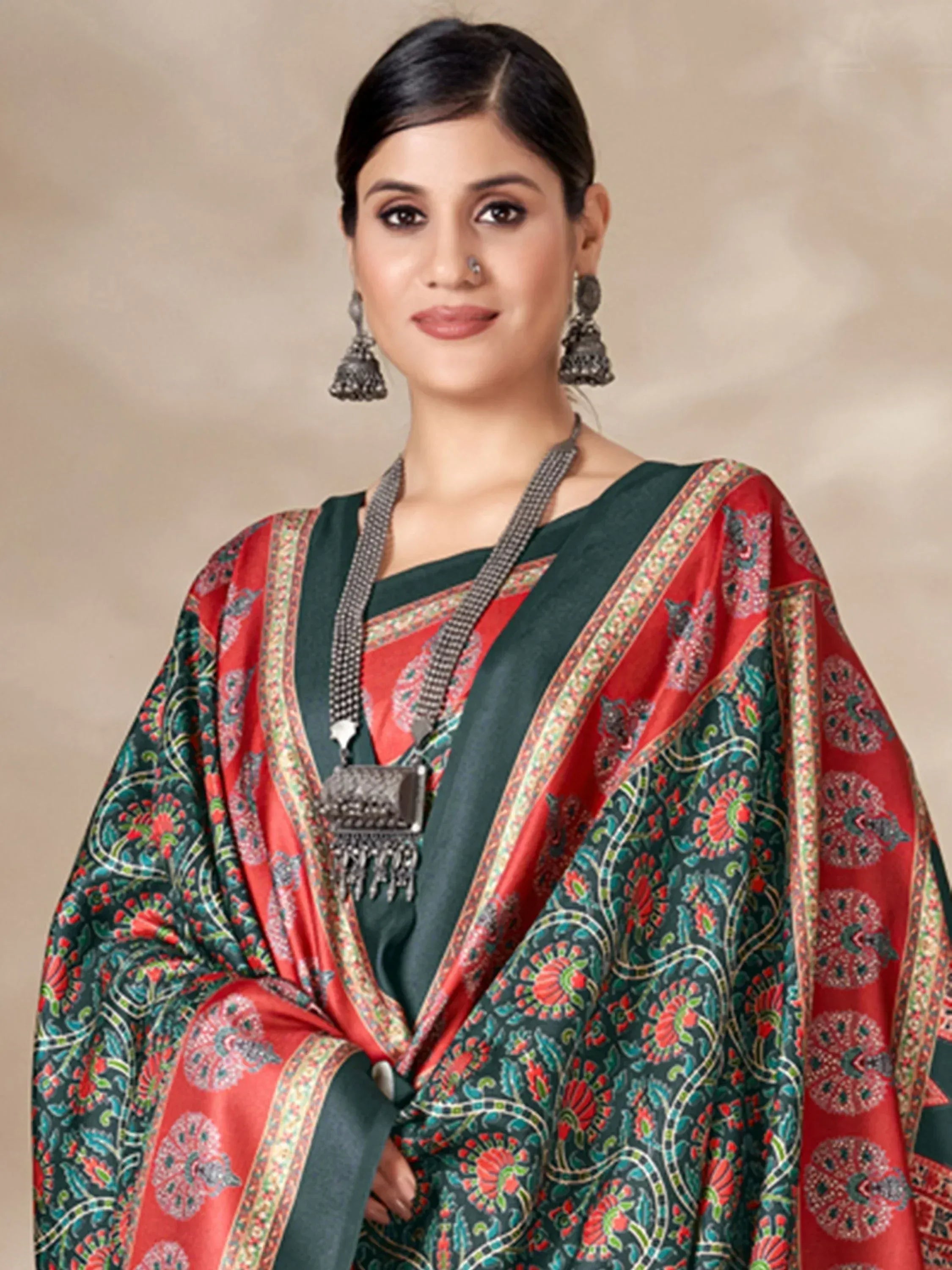 Woman in red and green printed saree with ethnic jewelry, traditional Indian wear