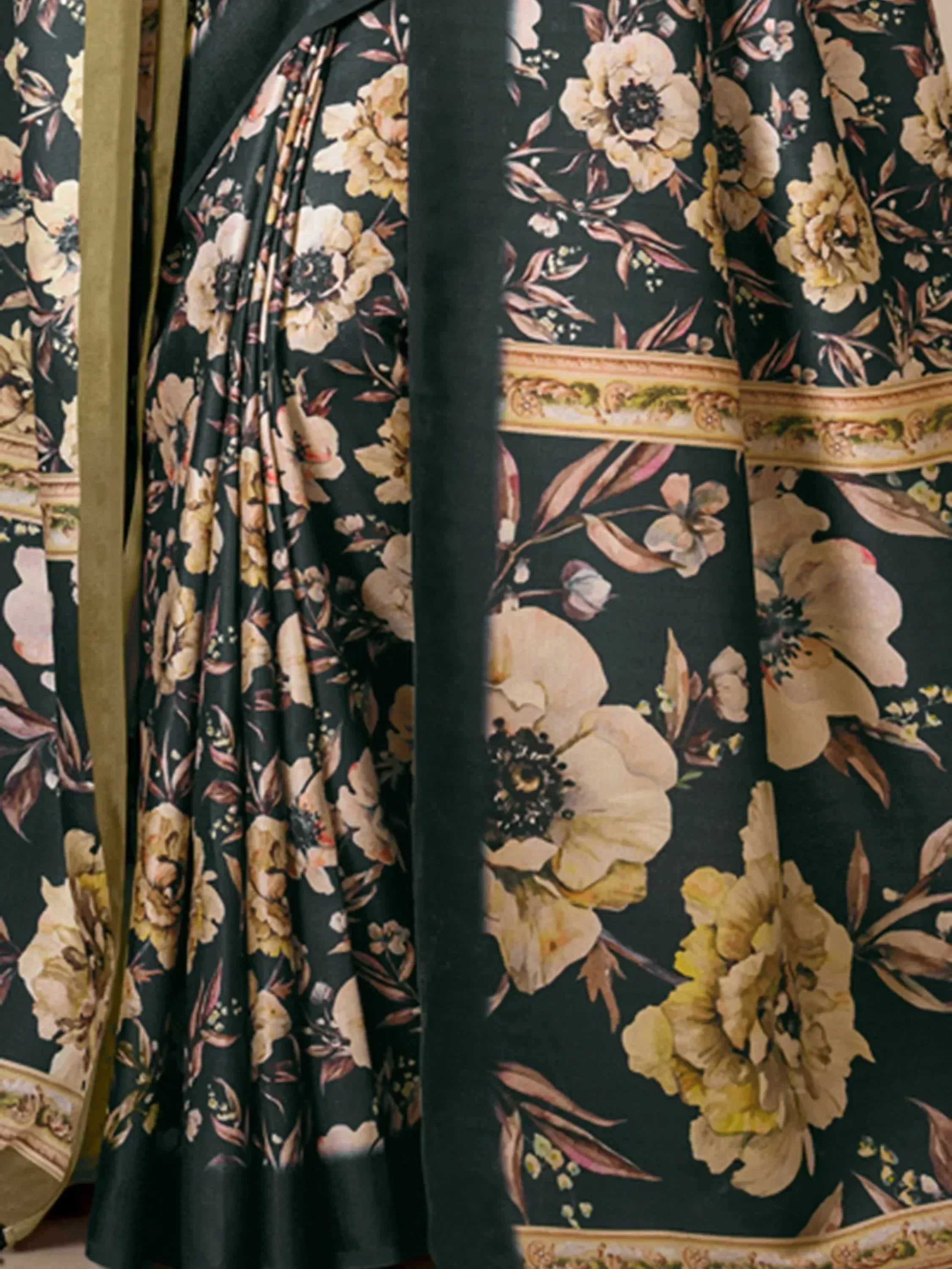 Elegant black floral saree with golden border, perfect for ethnic wear occasions.