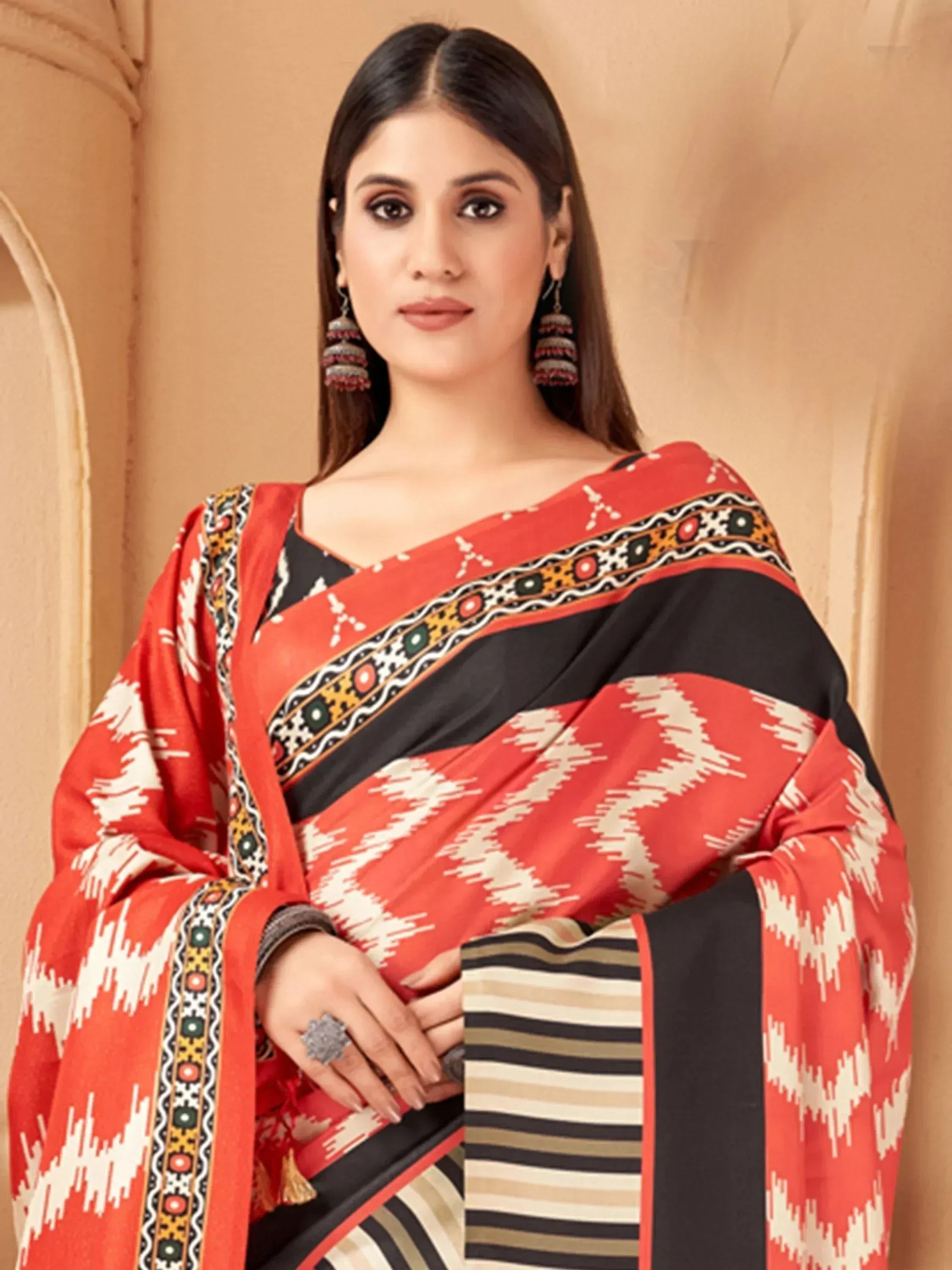 Woman in red and black printed saree with ethnic patterns, traditional Indian wear
