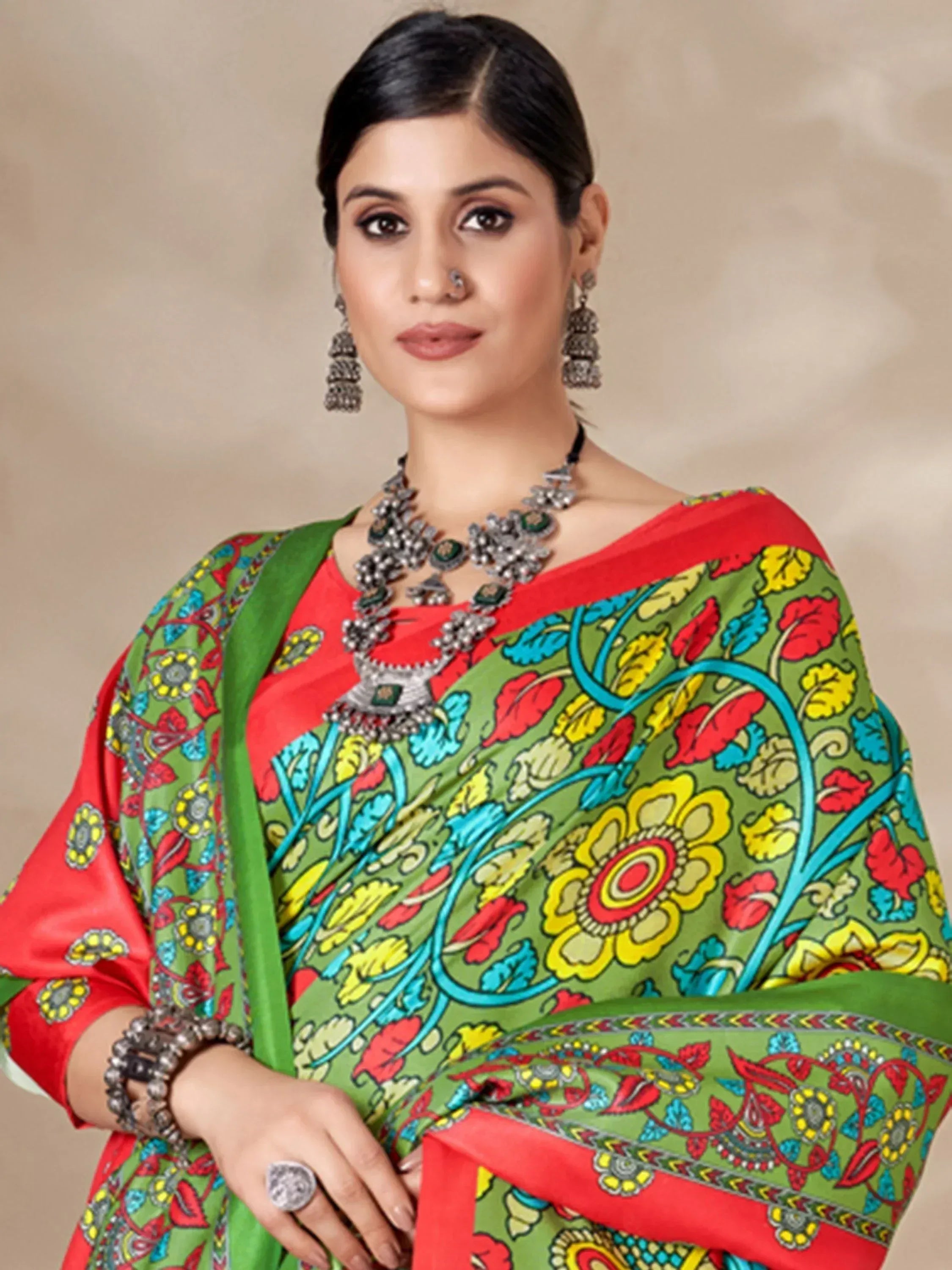 Vibrant green and red floral printed saree with traditional Indian jewelry, perfect for ethnic occasions.