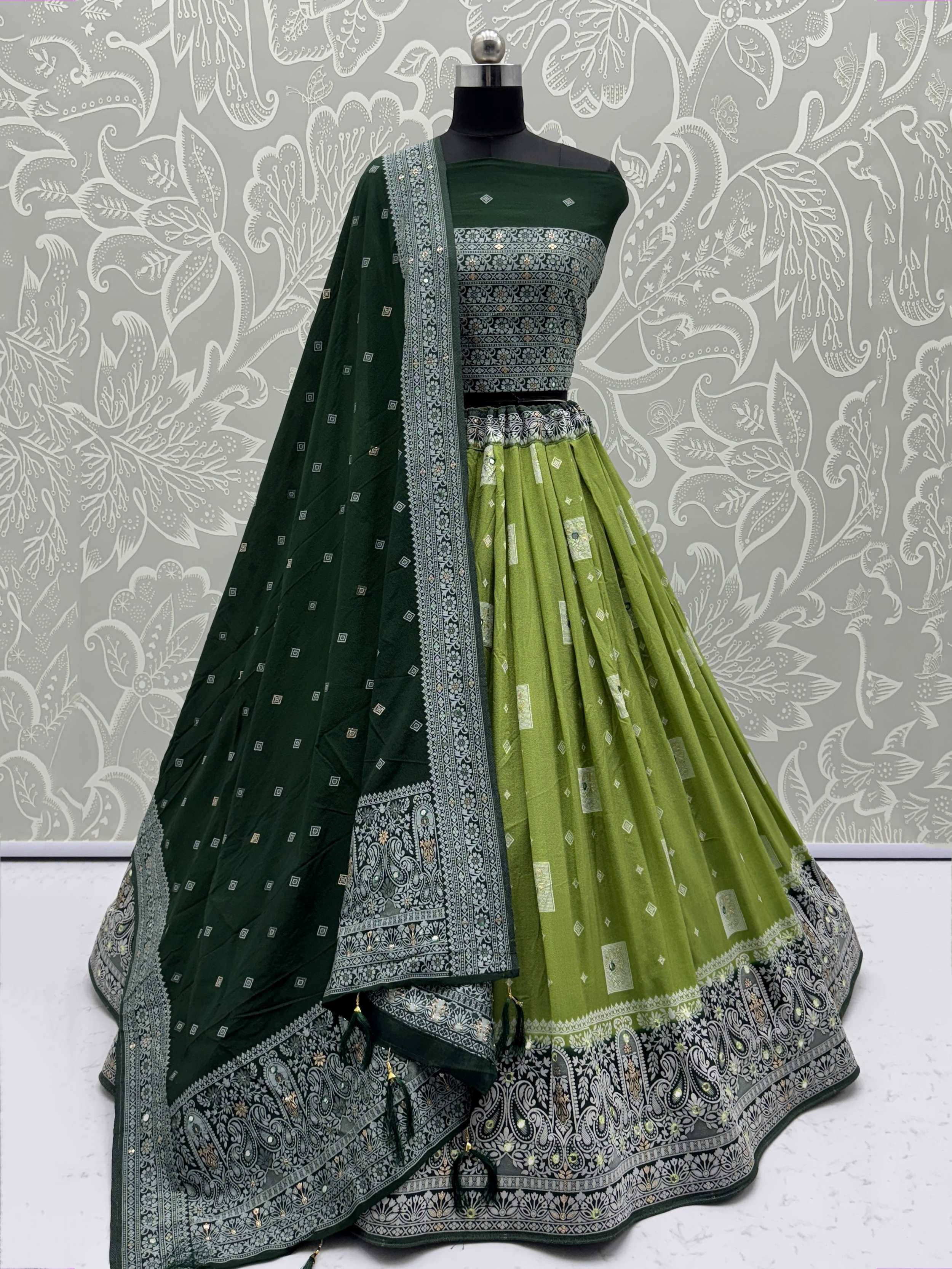 Green and olive designer lehenga choli with intricate paisley embroidery and matching dupatta, perfect for ethnic occasions.