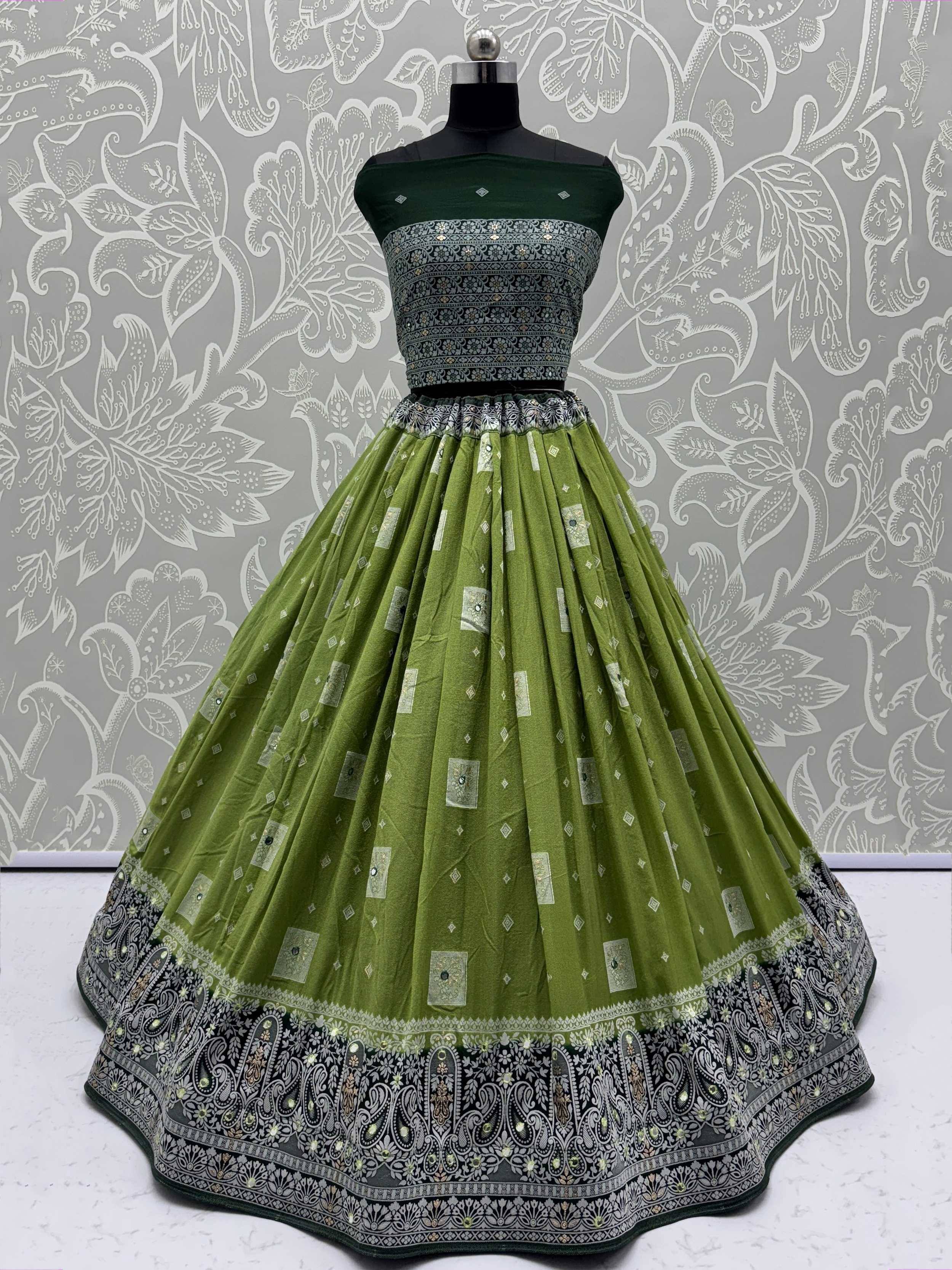 Green designer lehenga choli with intricate silver embroidery and floral border, perfect for Indian ethnic wear.