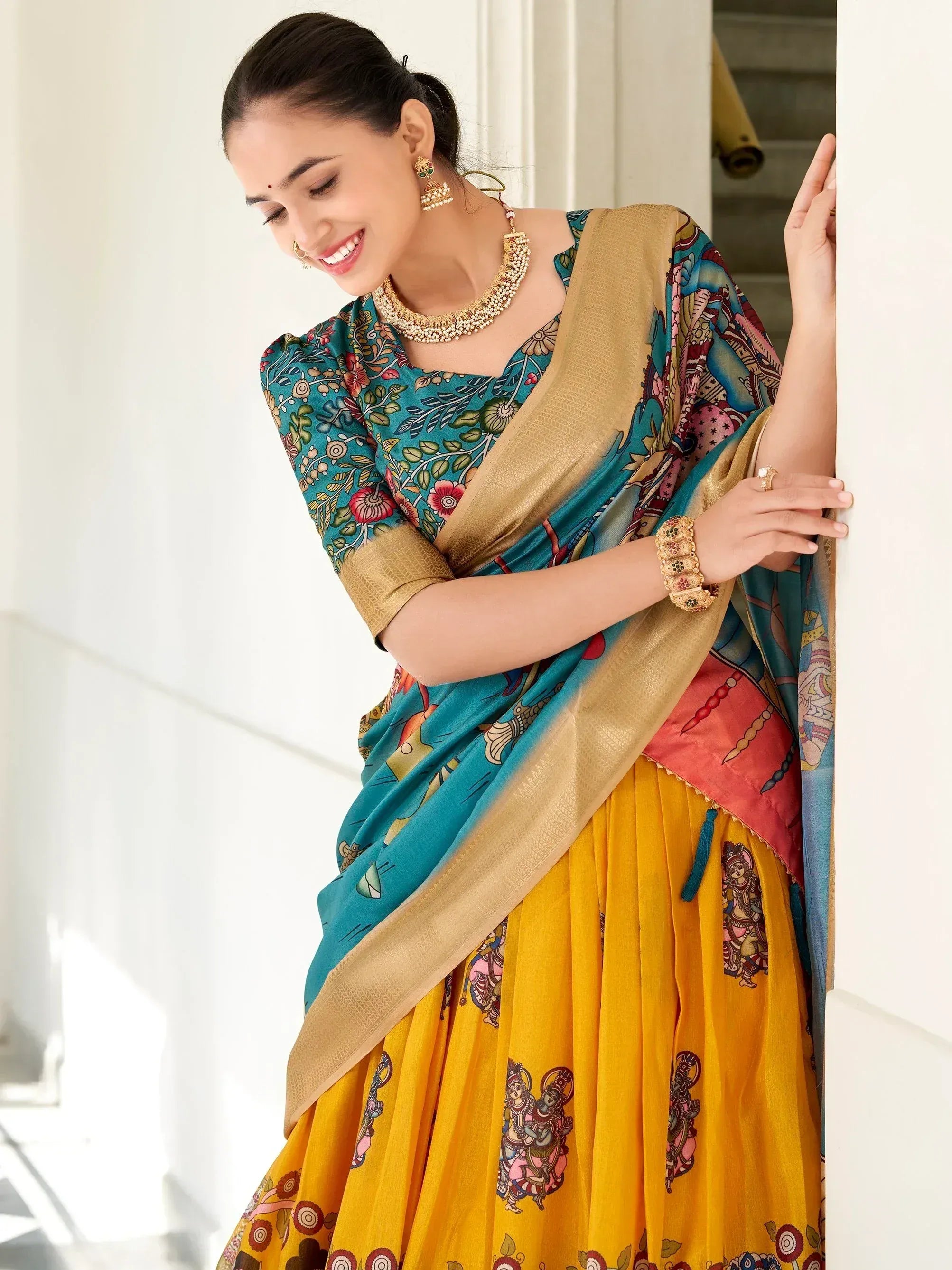 Woman in vibrant printed lehenga choli with gold border, traditional Indian ethnic wear for festive occasions