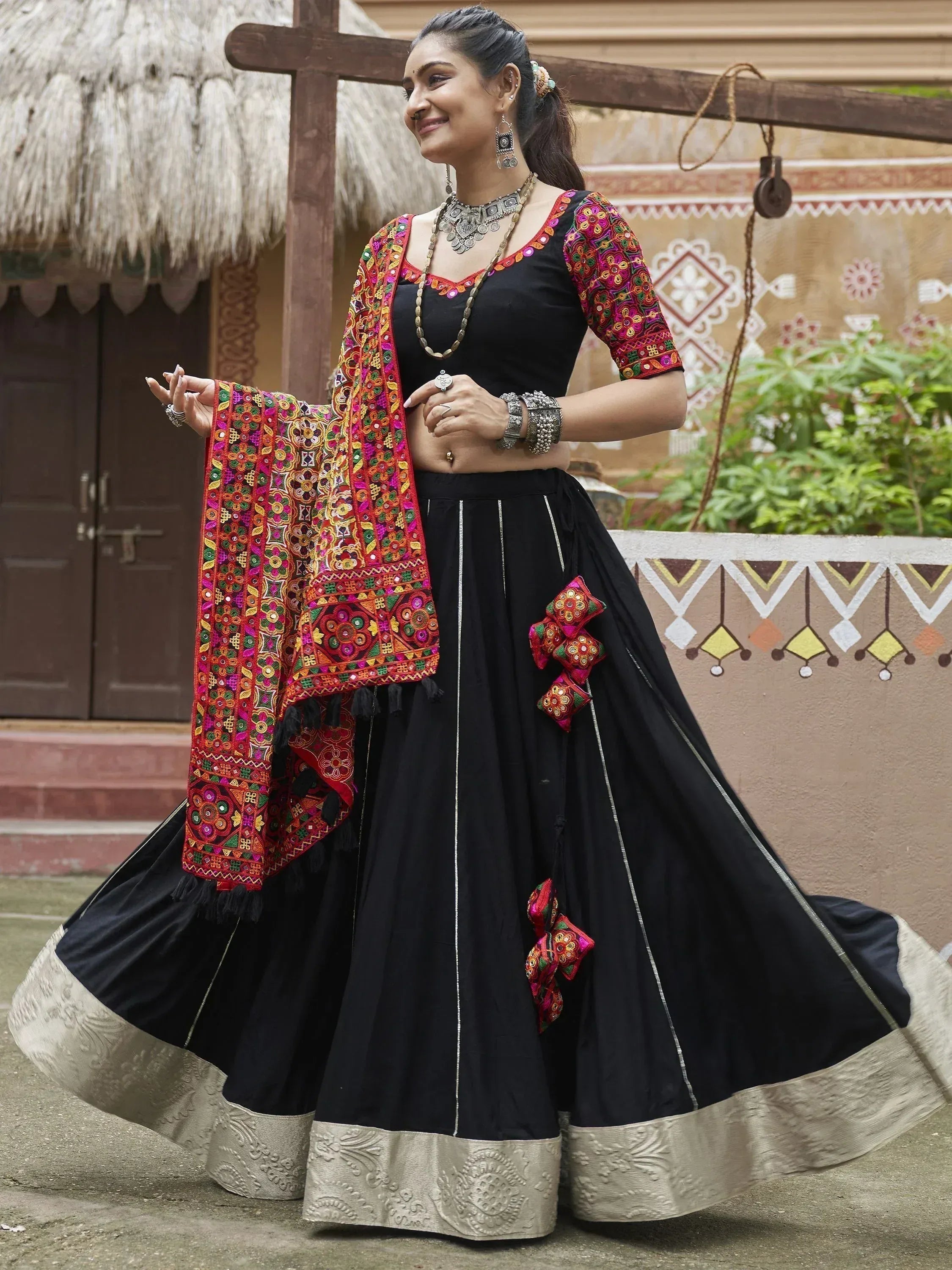 Black ethnic lehenga choli with vibrant mirror work dupatta, perfect for Indian festivals and weddings.