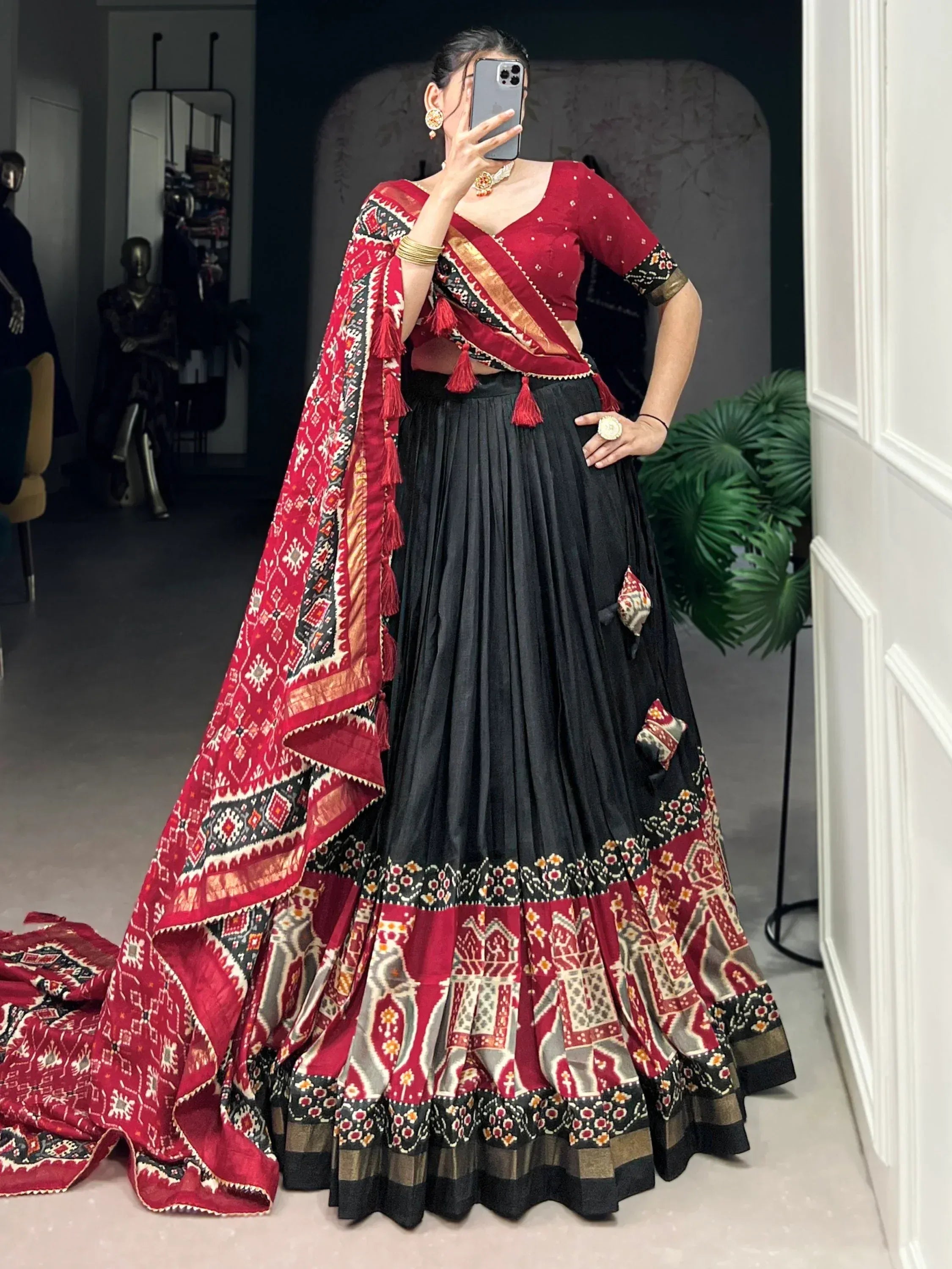 Red and black ethnic lehenga choli with printed dupatta, perfect for Indian weddings and festive occasions