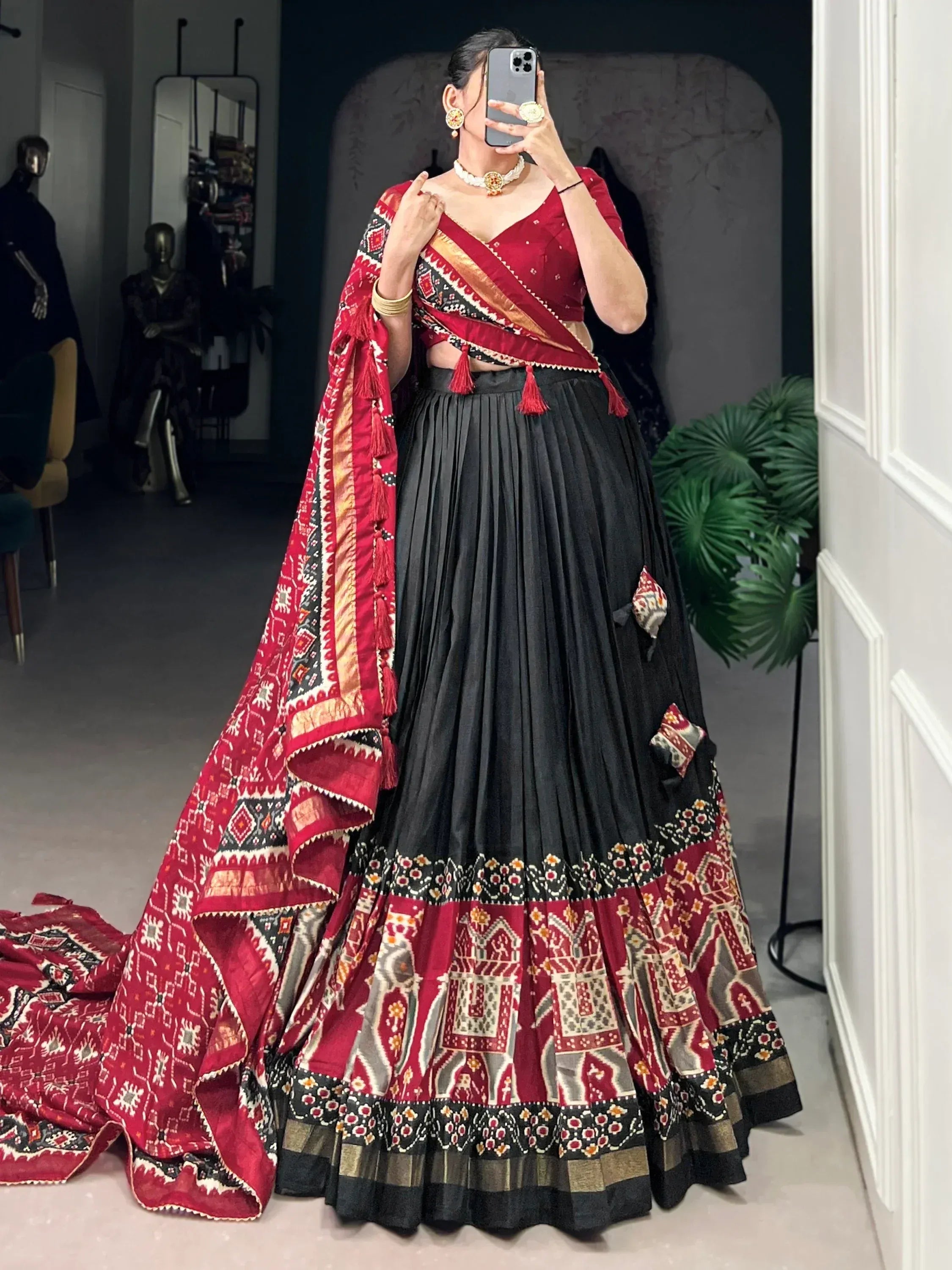 Red and black ethnic lehenga choli with printed dupatta, perfect for Indian weddings and festive occasions