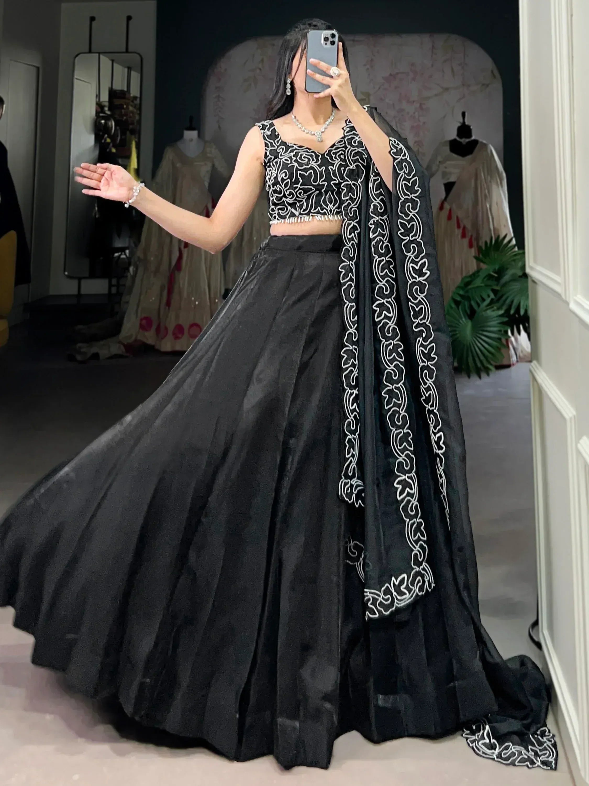 Black embroidered lehenga choli with white floral motifs, perfect for Indian ethnic wear occasions