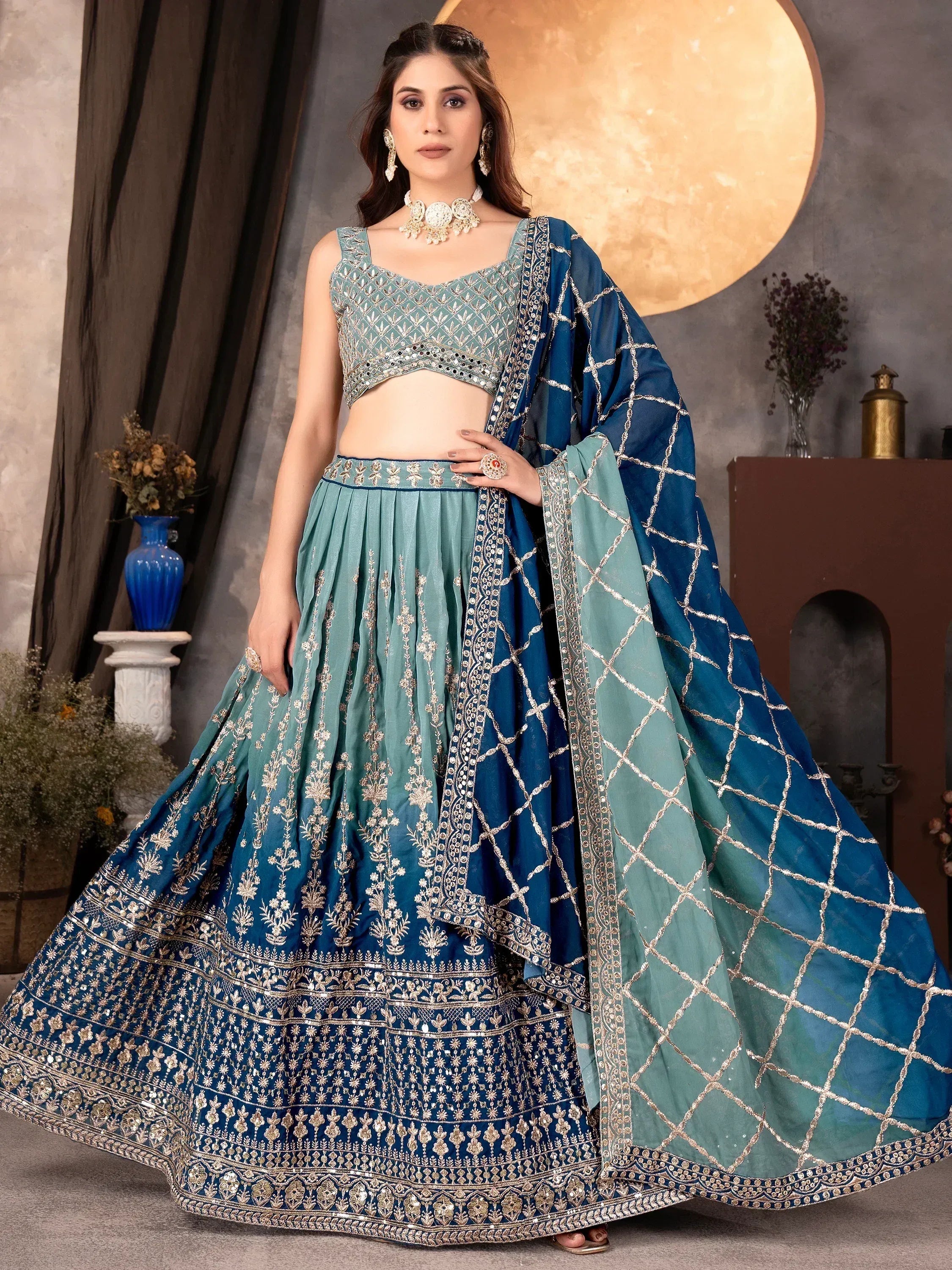 Blue and teal embroidered lehenga choli with gold detailing, perfect for Indian ethnic wear occasions.