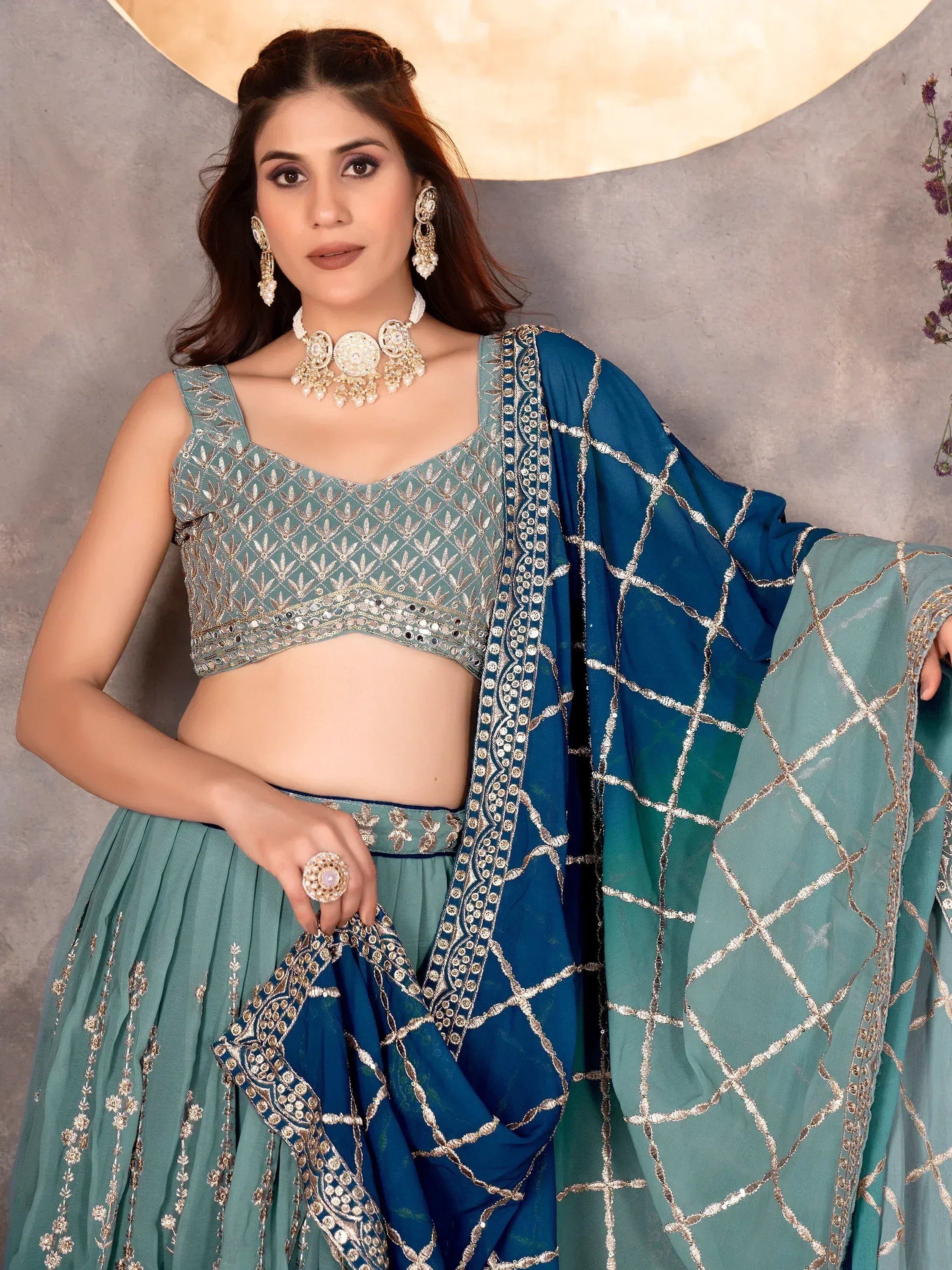 Teal embroidered lehenga choli with gold detailing, perfect for Indian ethnic wear events