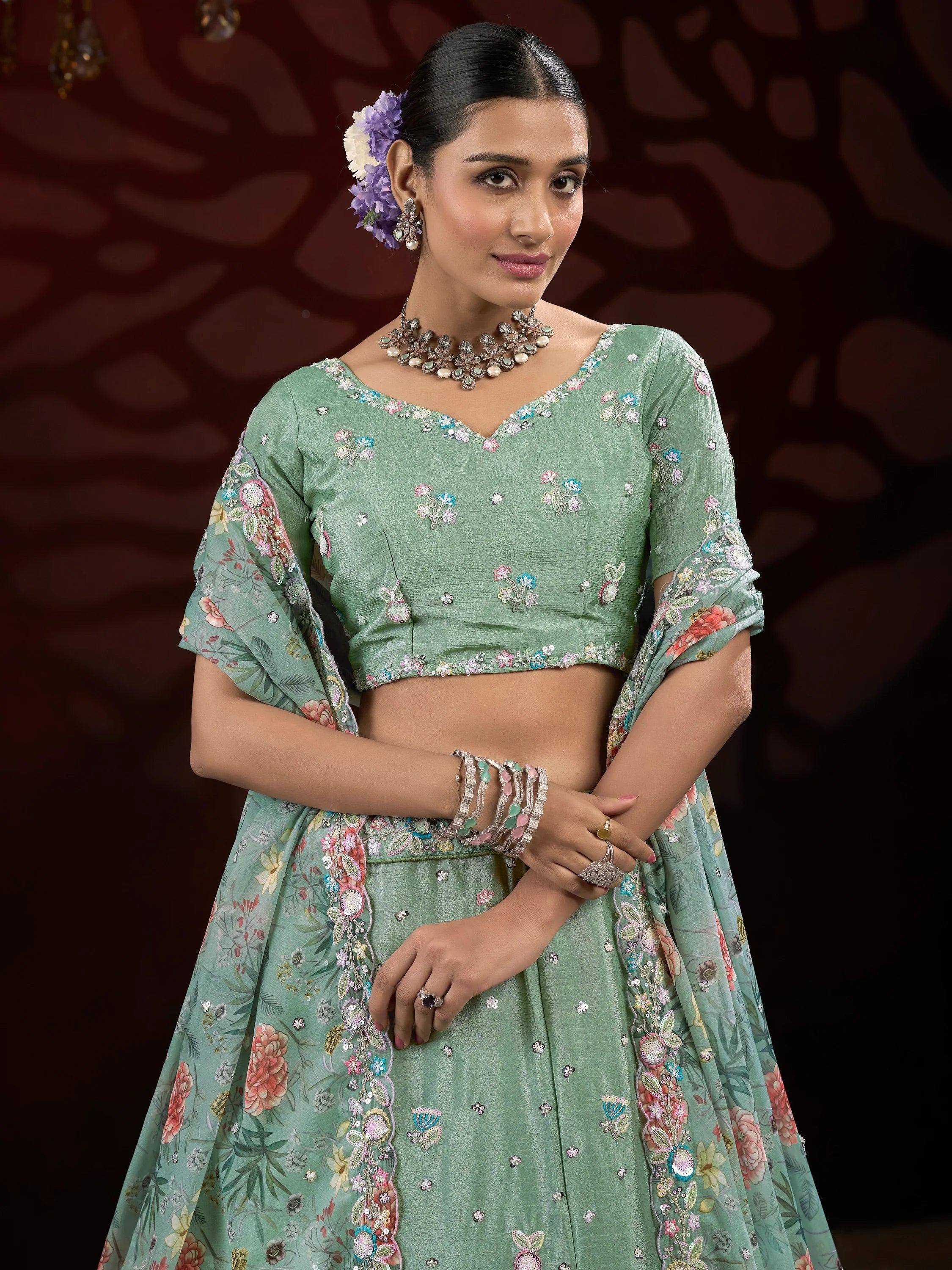 Mint green floral embroidered lehenga choli with sheer sleeves, perfect for Indian ethnic wear occasions.