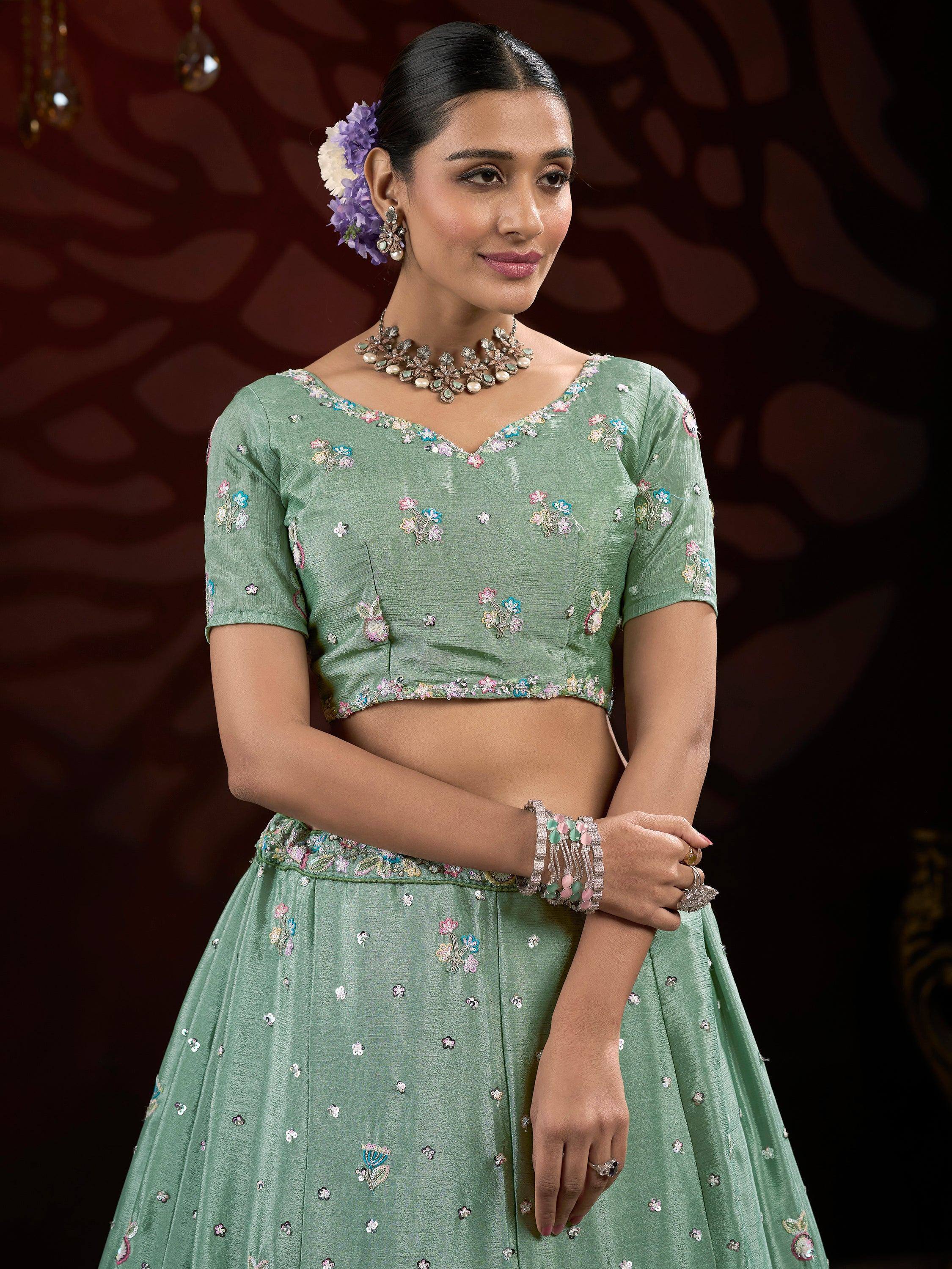 Mint green embroidered lehenga choli with floral motifs, perfect for Indian ethnic wear and festive occasions.