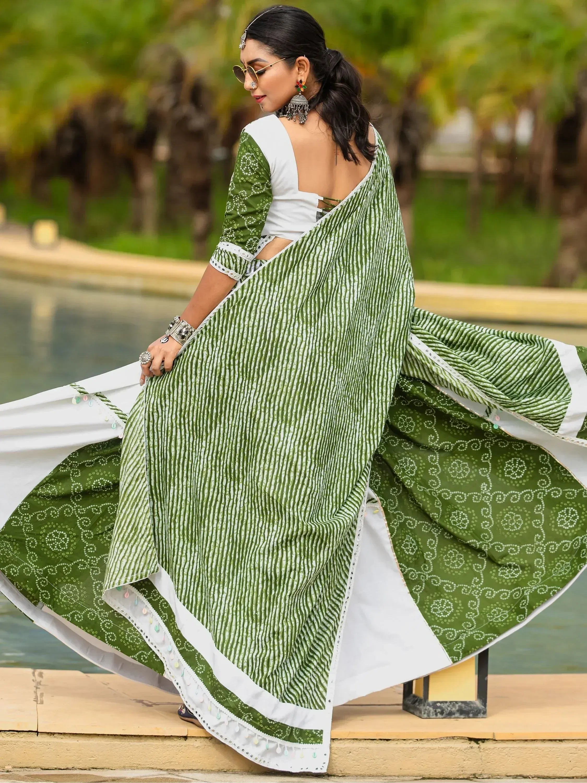 Green and white printed saree with ethnic jewelry, perfect for Indian occasions