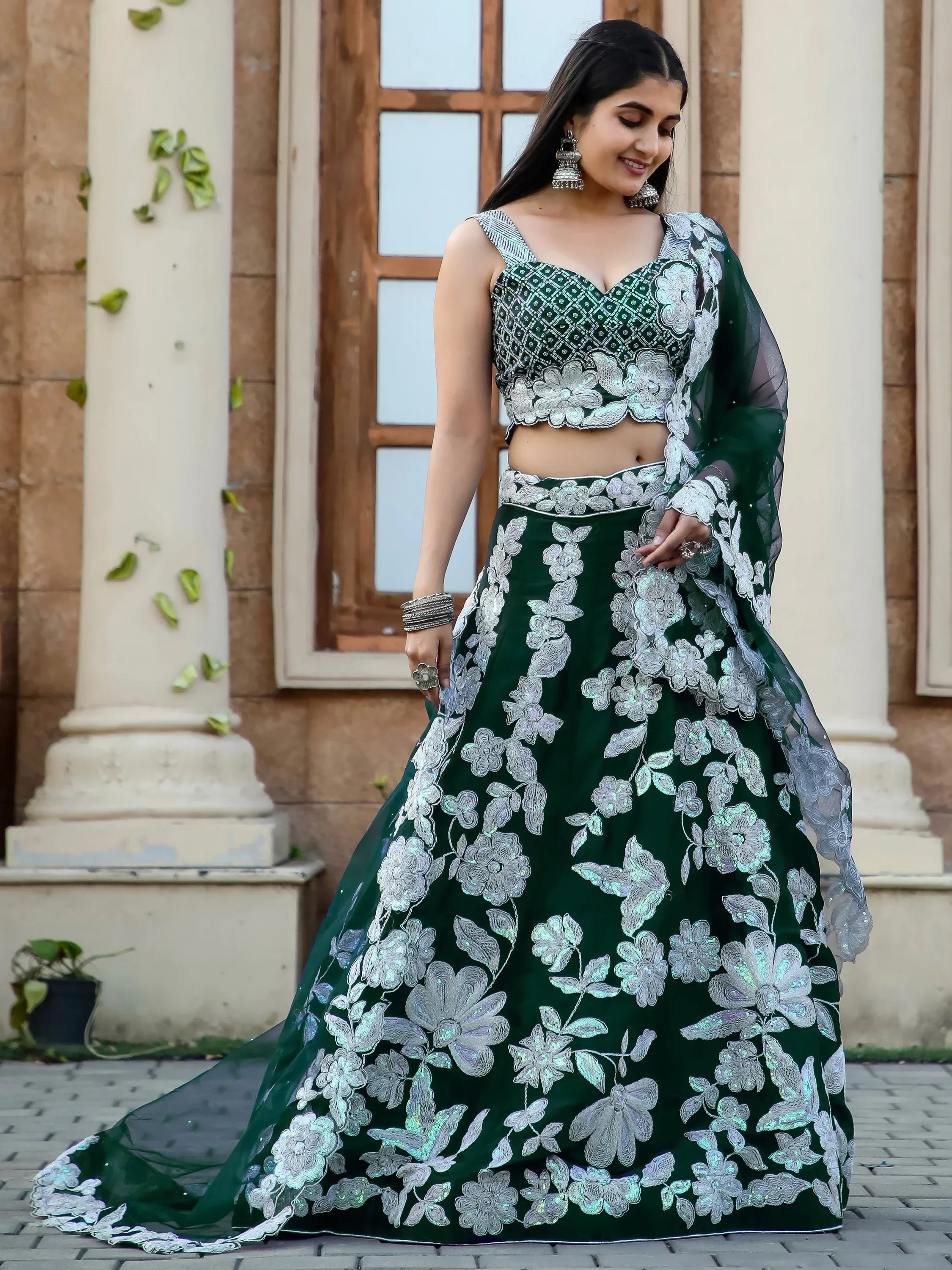 Emerald green lehenga choli with silver floral embroidery, perfect for Indian ethnic occasions