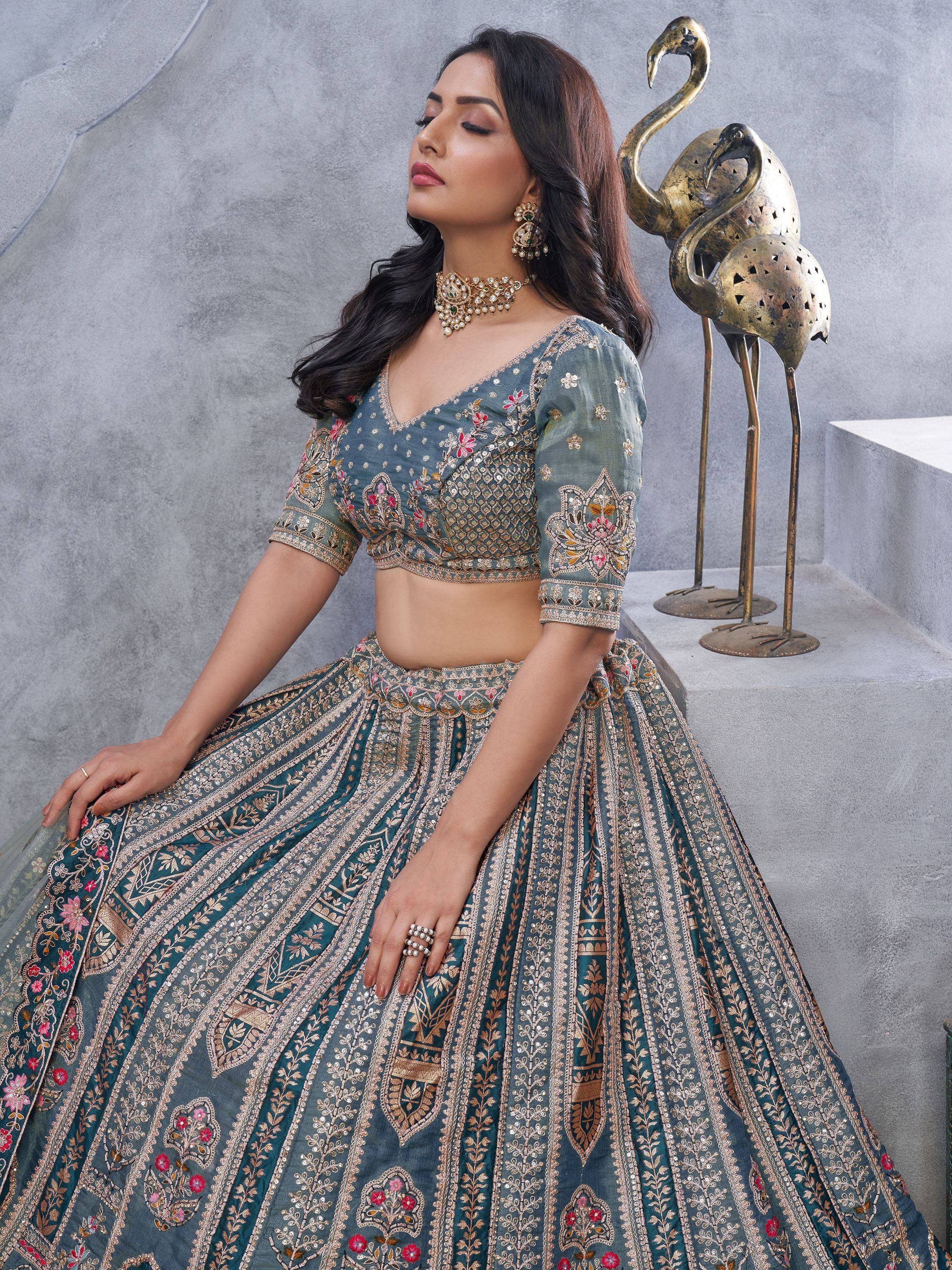 Teal embroidered lehenga choli with floral motifs and gold detailing, perfect for Indian ethnic wear occasions.