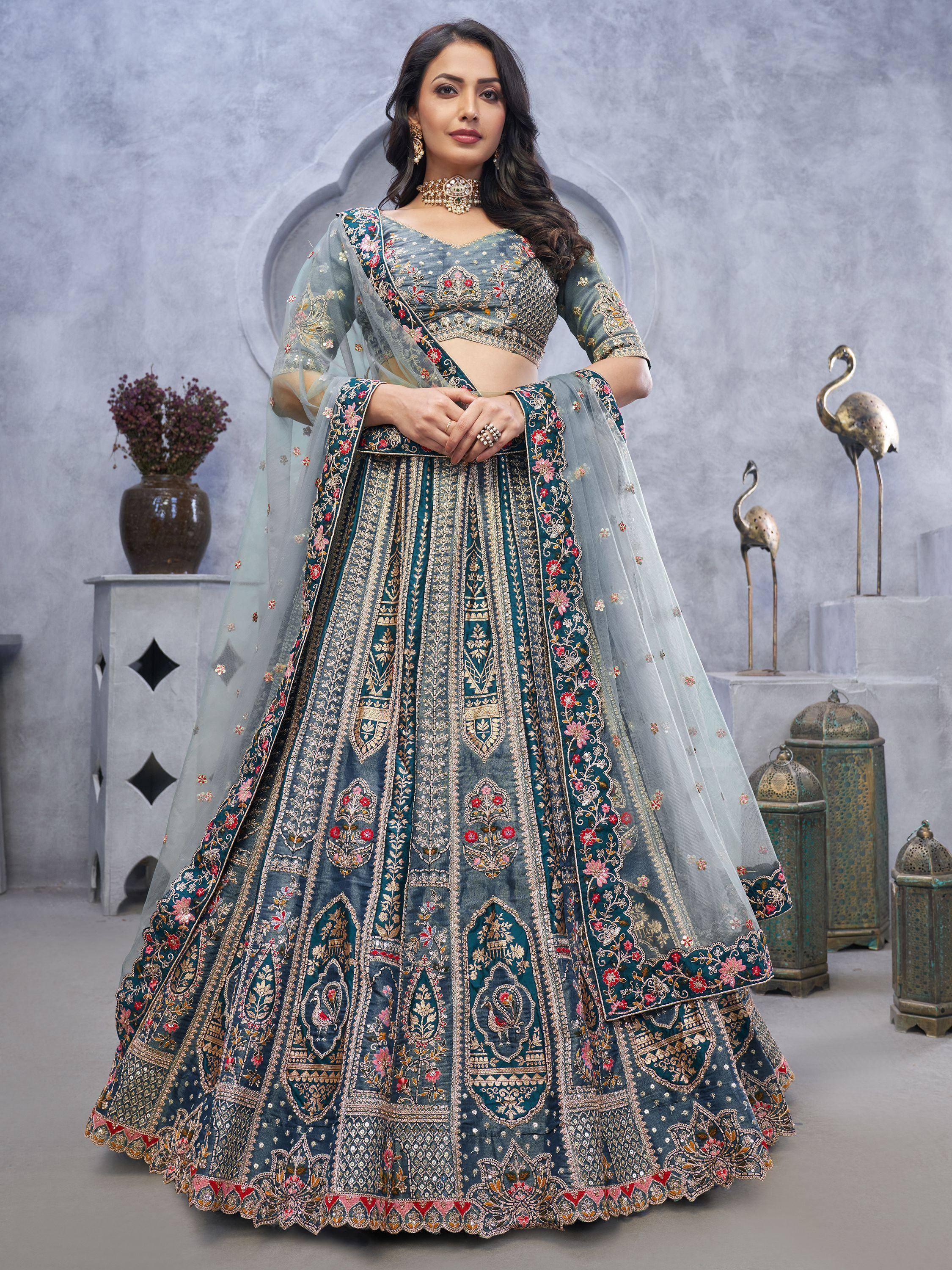Elegant teal designer lehenga choli with intricate gold embroidery and floral motifs, perfect for Indian weddings.