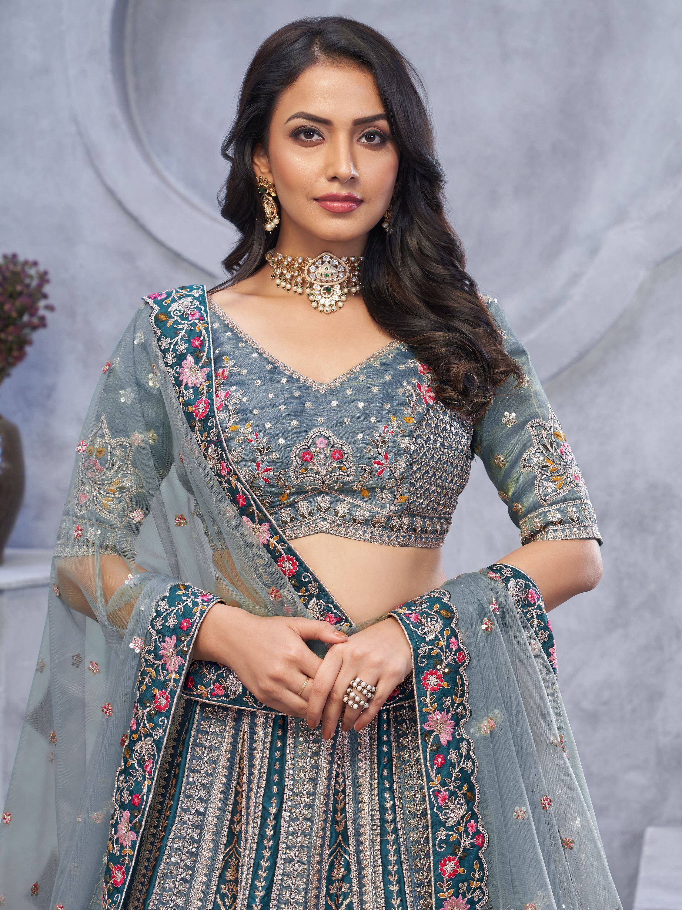 Elegant teal lehenga choli with floral embroidery and sheer dupatta, perfect for Indian ethnic wear occasions.