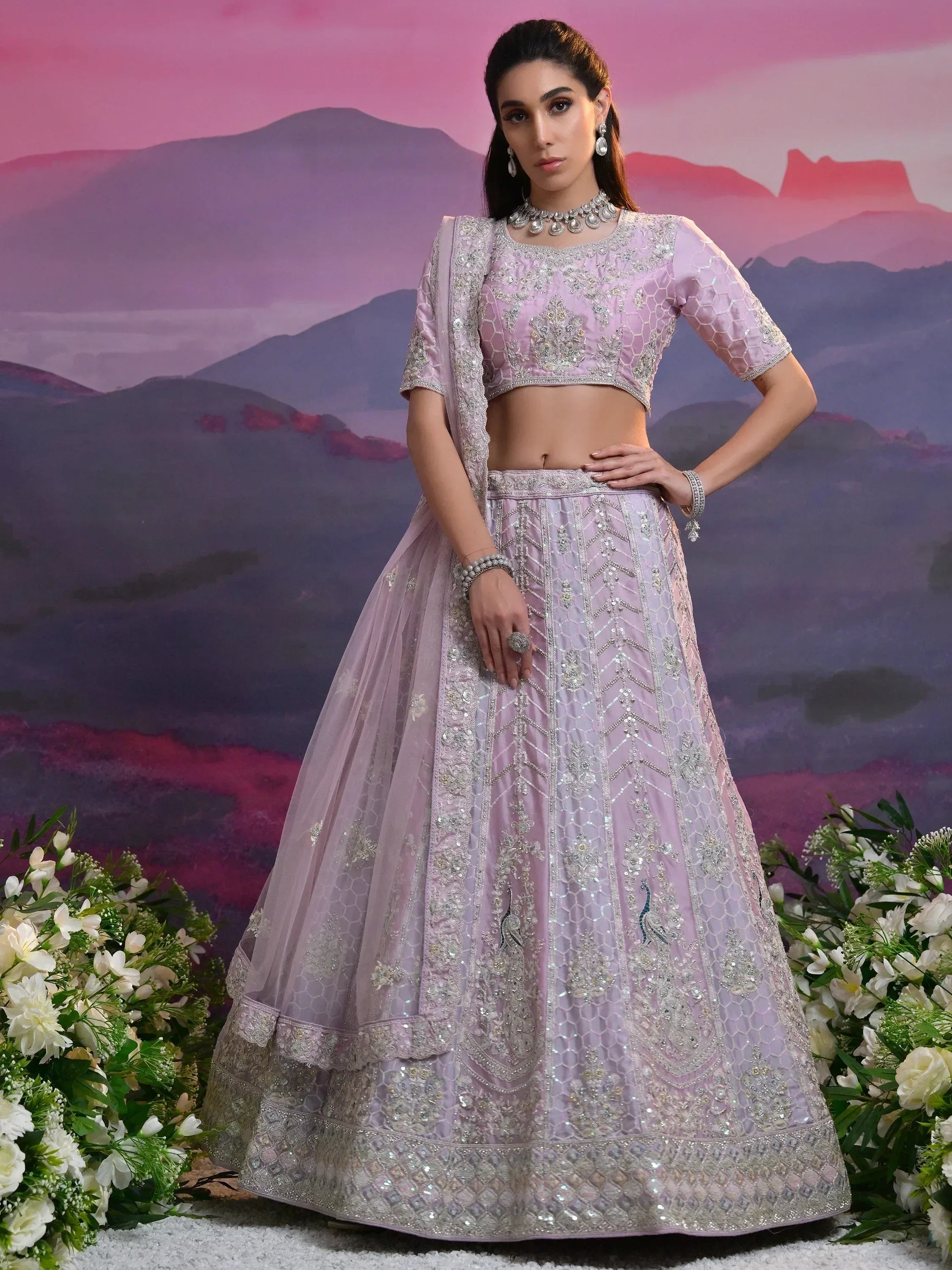 Elegant lavender lehenga choli with intricate silver embroidery, perfect for Indian weddings and festive occasions.