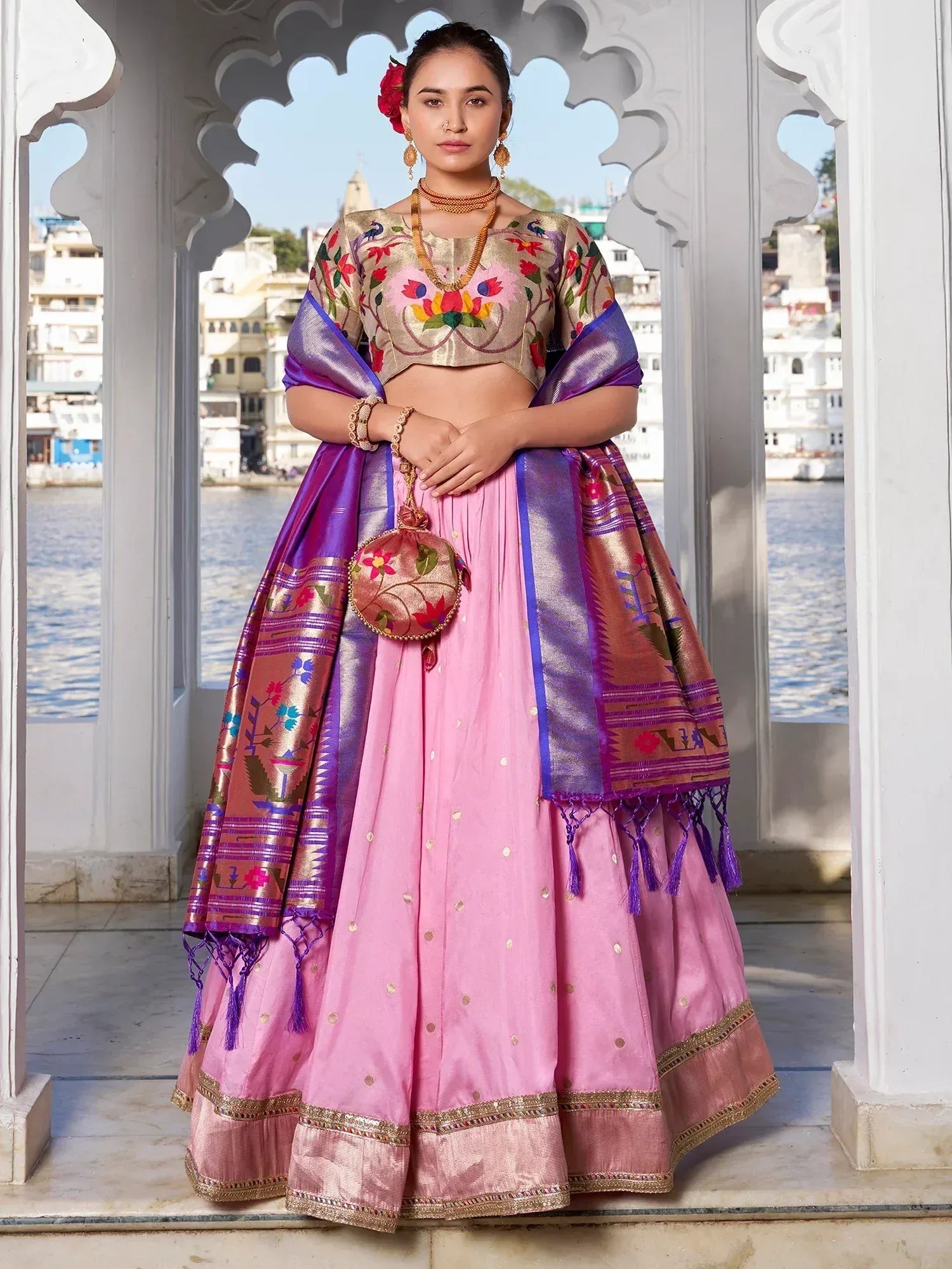 Pink embroidered lehenga choli with purple dupatta, floral blouse, and gold accents for Indian ethnic wear