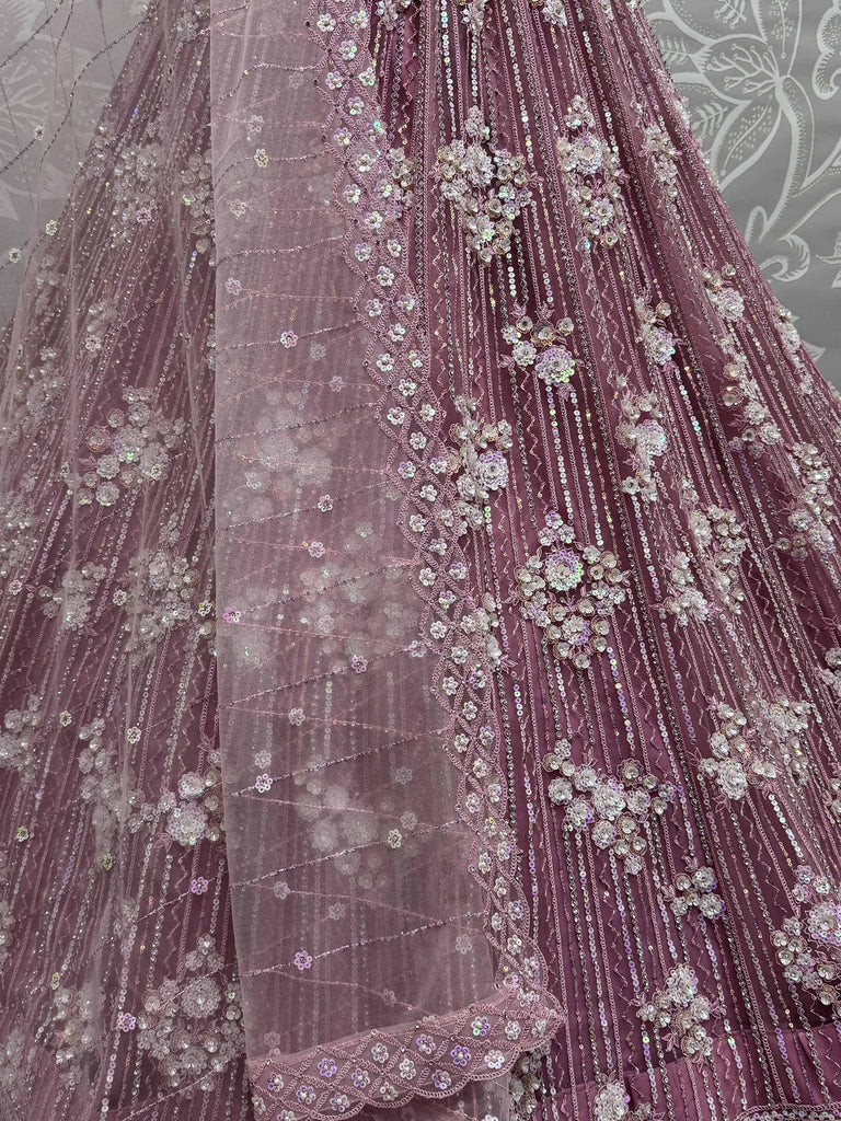Dusty rose designer lehenga with floral sequin embroidery and sheer overlay, perfect for Indian weddings.