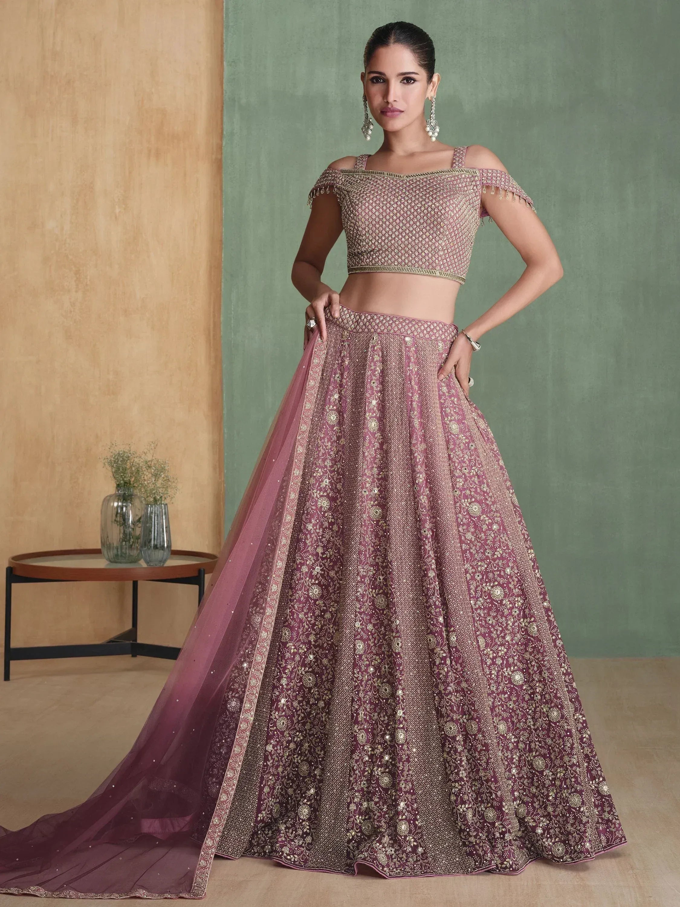 Elegant mauve lehenga choli with gold embroidery, off-shoulder blouse, and flowing dupatta for Indian ethnic wear