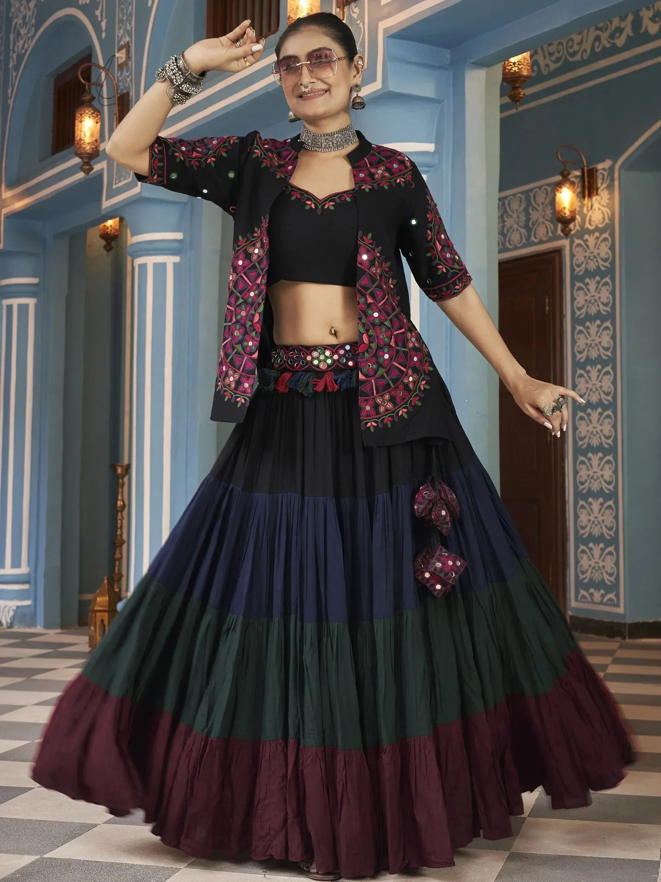 Black embroidered lehenga choli with colorful tiered skirt, perfect for Indian ethnic wear events