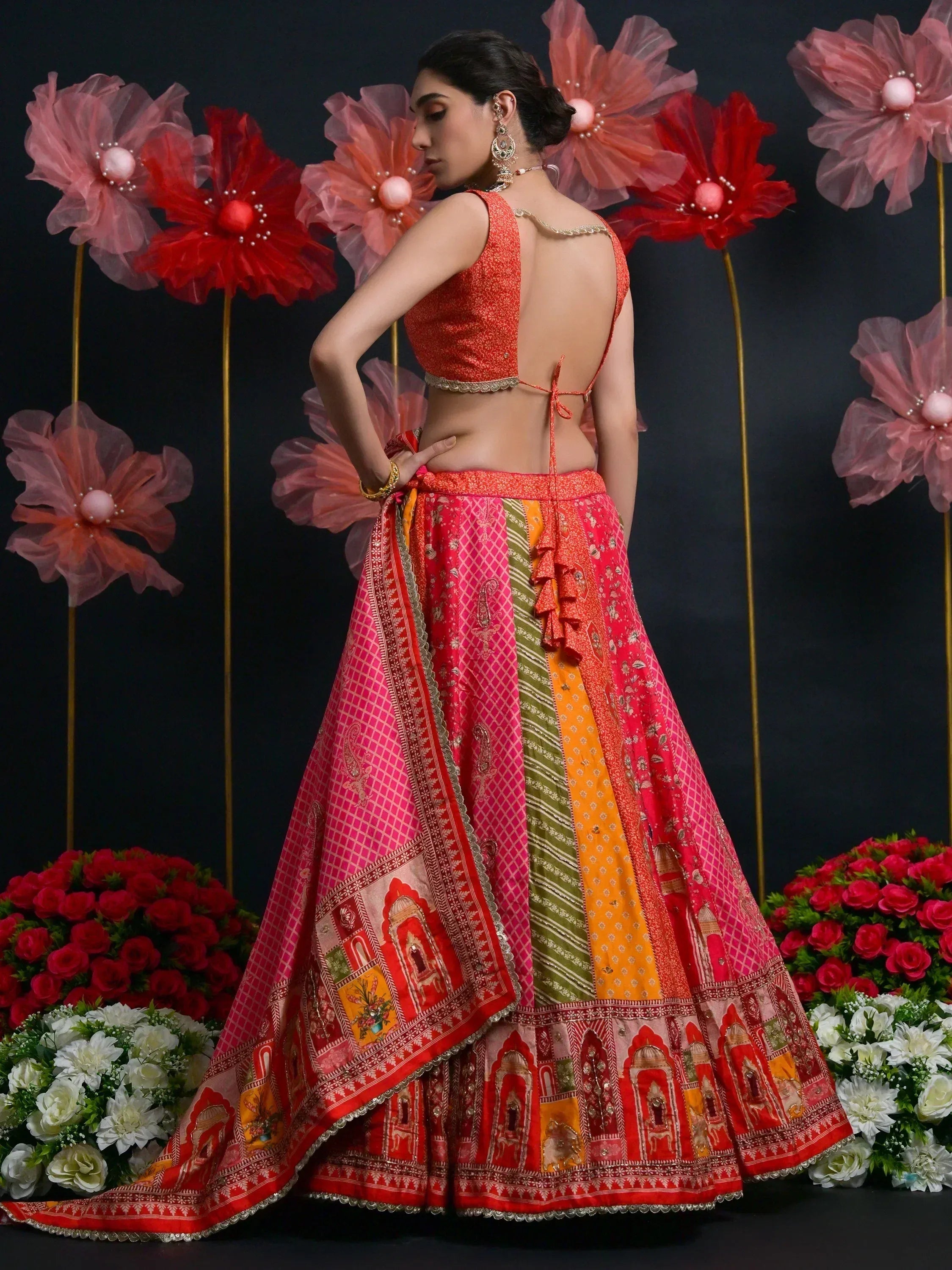 Vibrant red and pink printed lehenga choli with open back blouse, perfect for Indian ethnic wear occasions