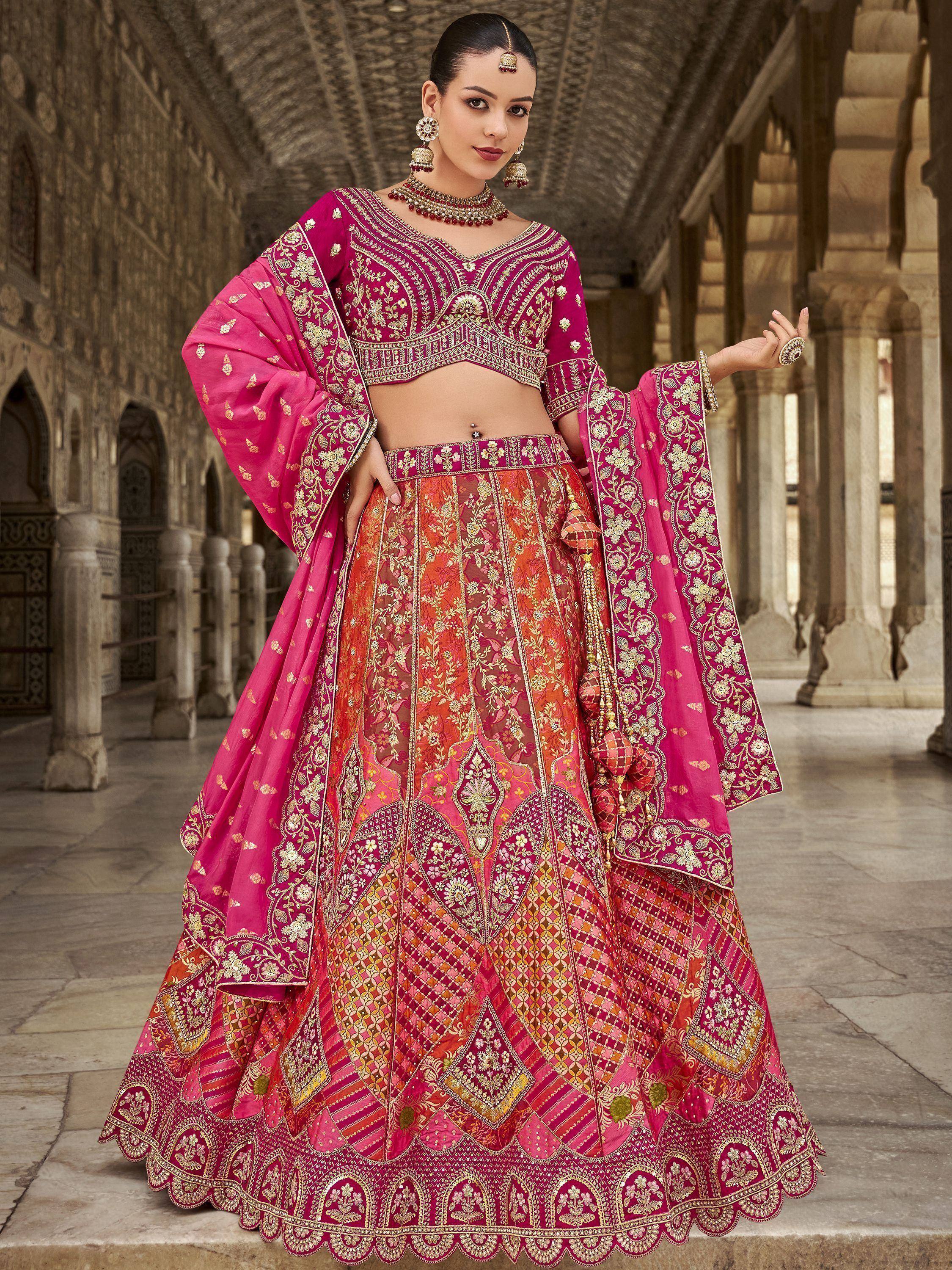 Pink and orange embroidered lehenga choli with gold detailing, perfect for Indian weddings and festive occasions.