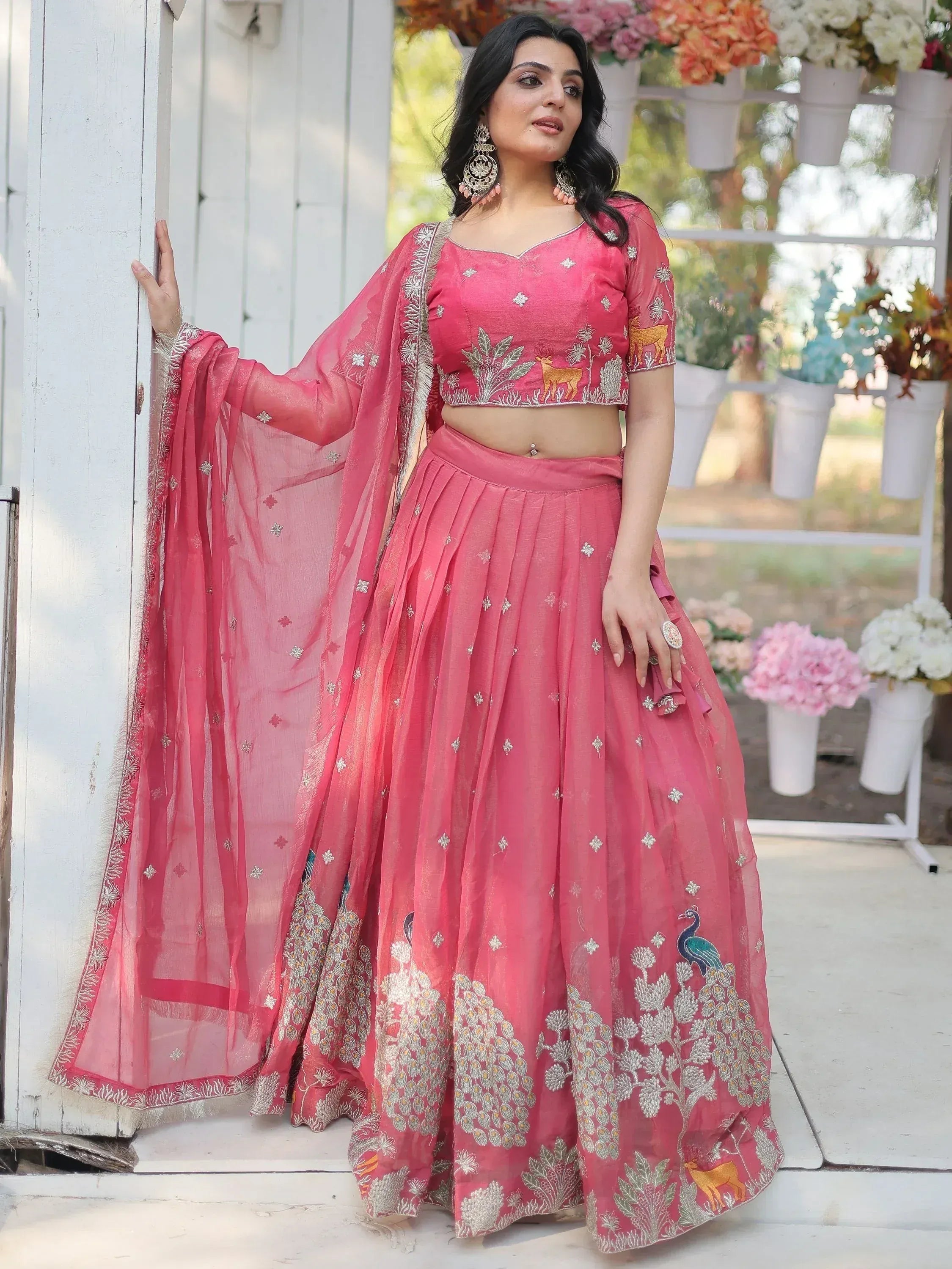 Pink embroidered lehenga choli with deer and peacock motifs, perfect for Indian ethnic occasions