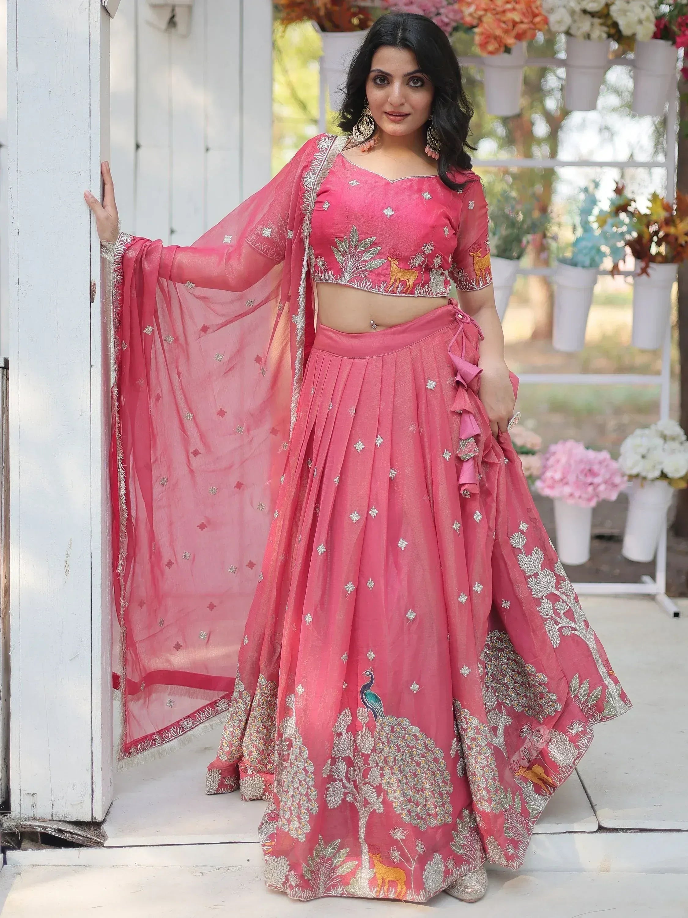 Pink embroidered lehenga choli with peacock and deer motifs, perfect for Indian ethnic wear occasions