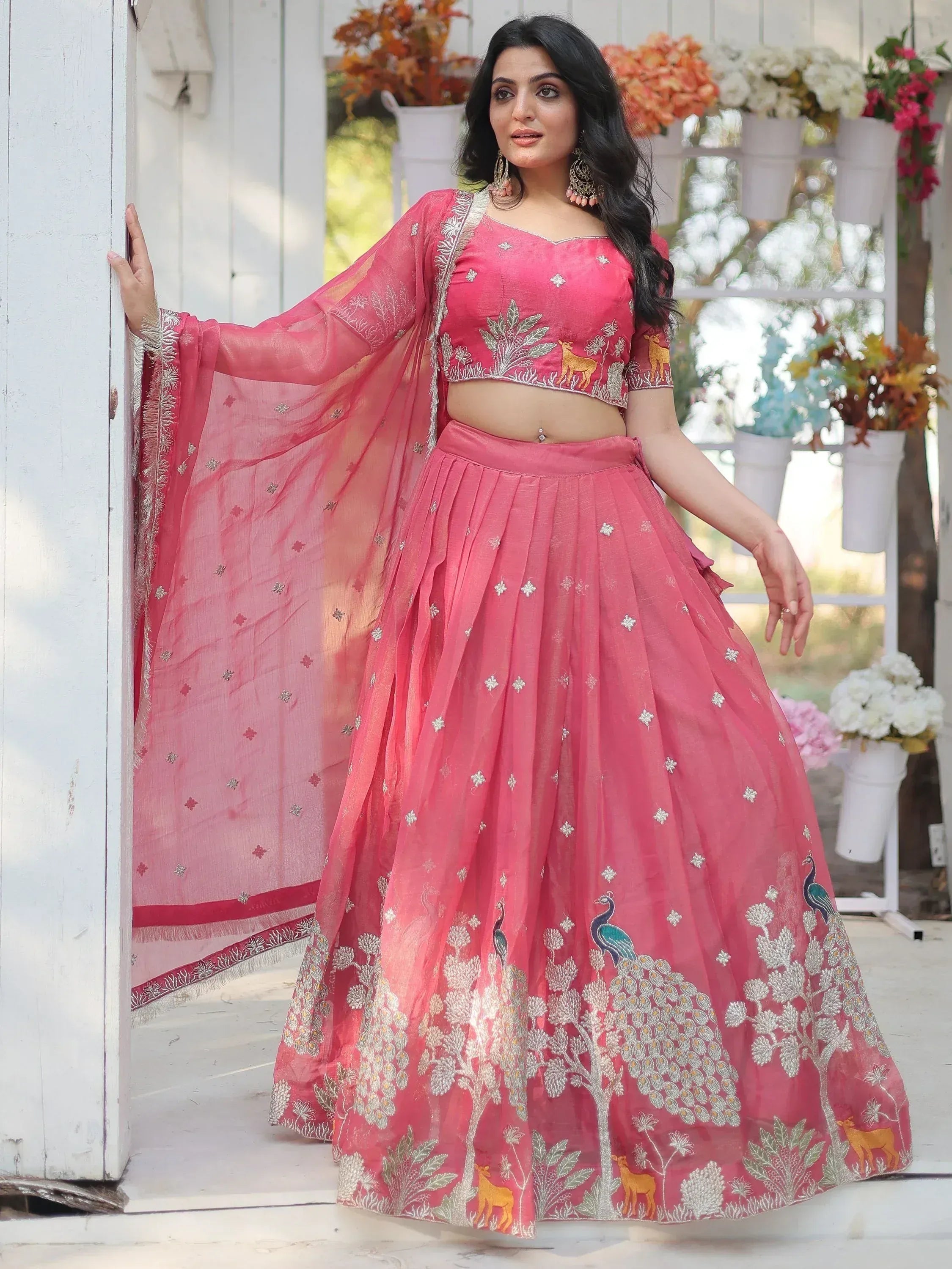 Pink embroidered lehenga choli with peacock and deer motifs, perfect for Indian ethnic wear occasions
