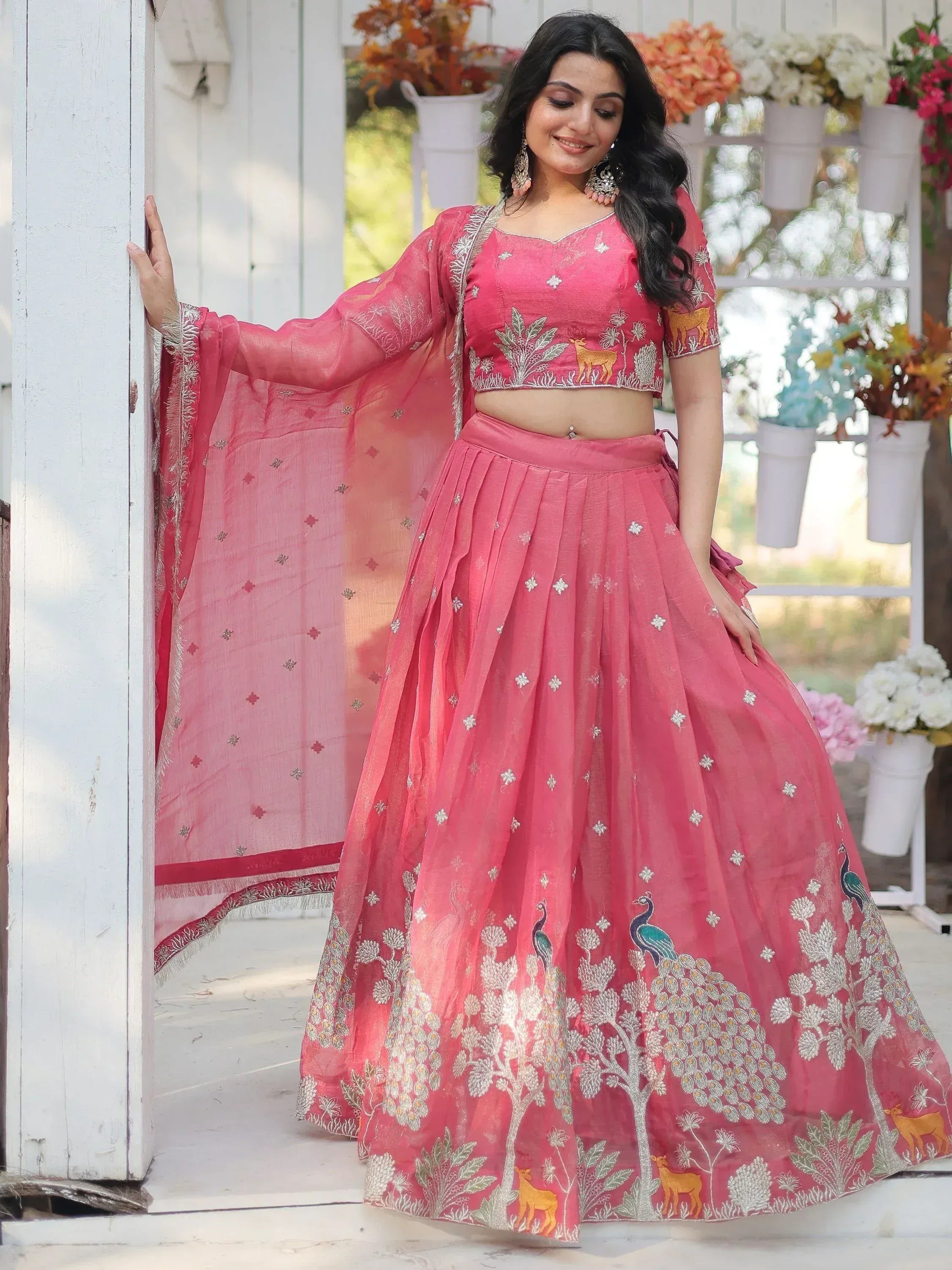 Pink embroidered lehenga choli with peacock and deer motifs, perfect for Indian ethnic wear occasions