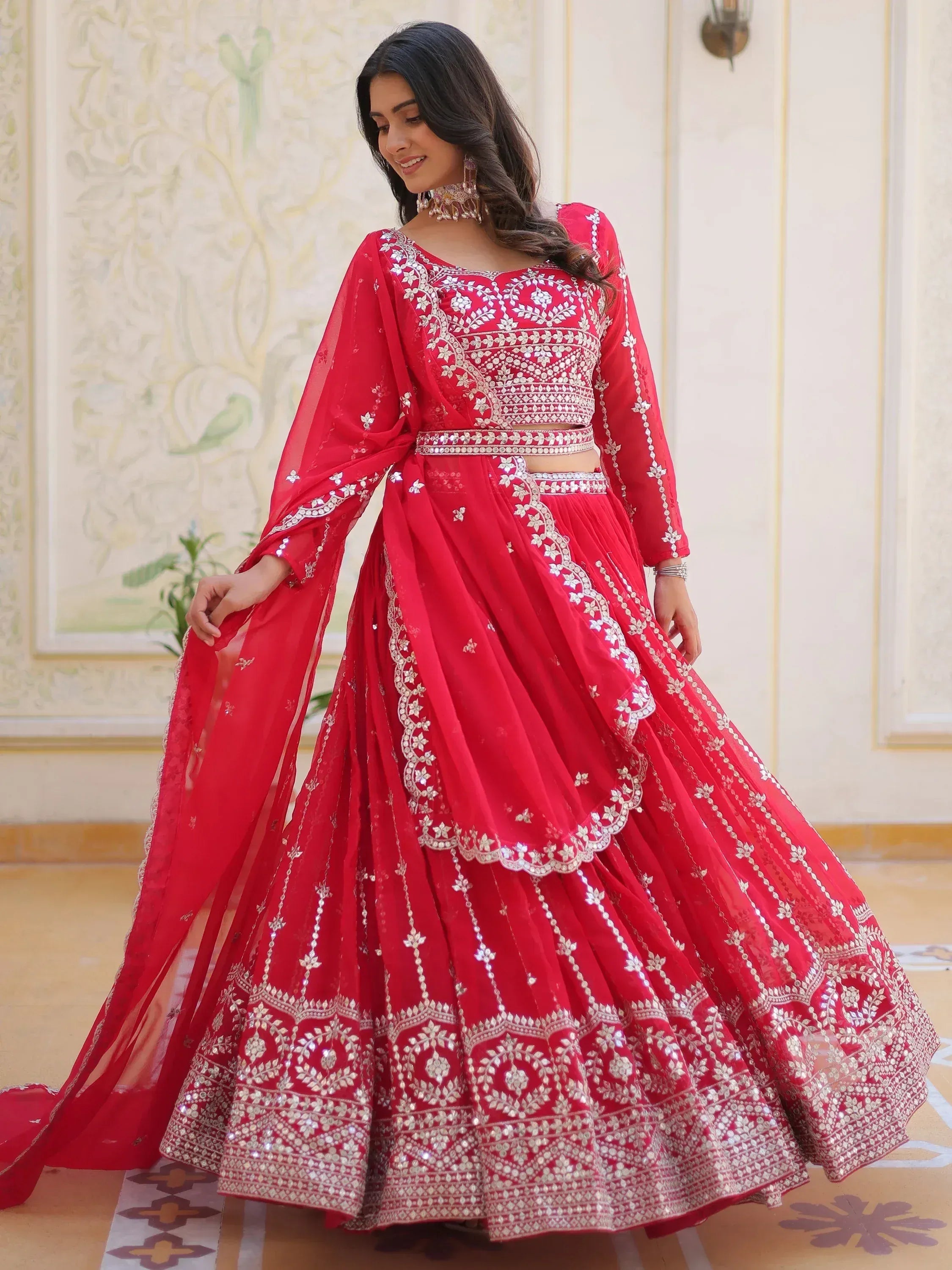 Red designer lehenga choli with silver embroidery, perfect for weddings and festive occasions