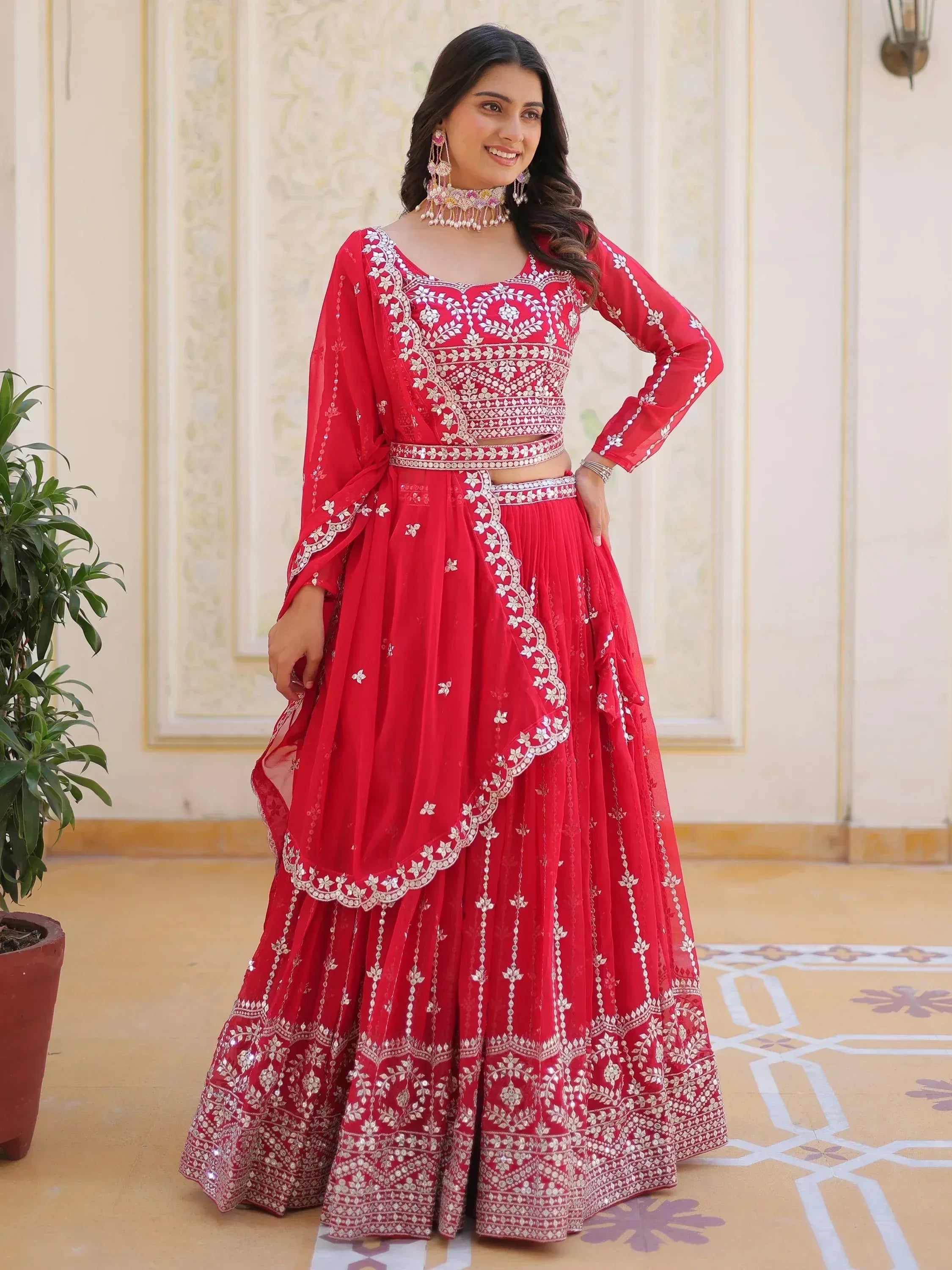 Red embroidered lehenga choli with silver work, perfect for Indian weddings and festive occasions