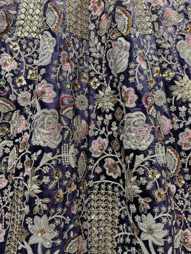 Purple ethnic gown with intricate floral embroidery and sequin detailing for festive occasions