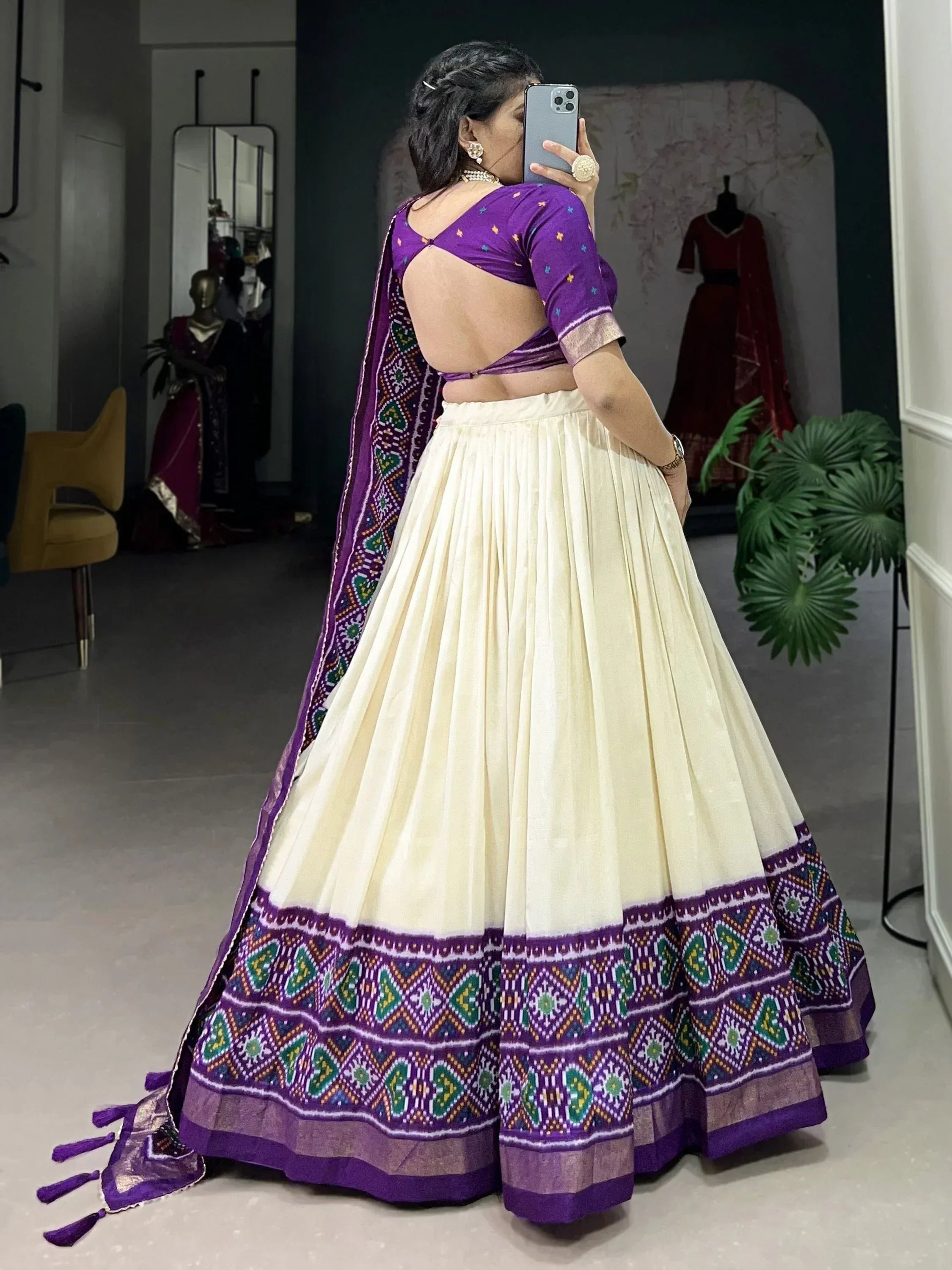 Purple and cream ethnic lehenga choli with backless blouse and printed dupatta, perfect for Indian weddings or festivals.