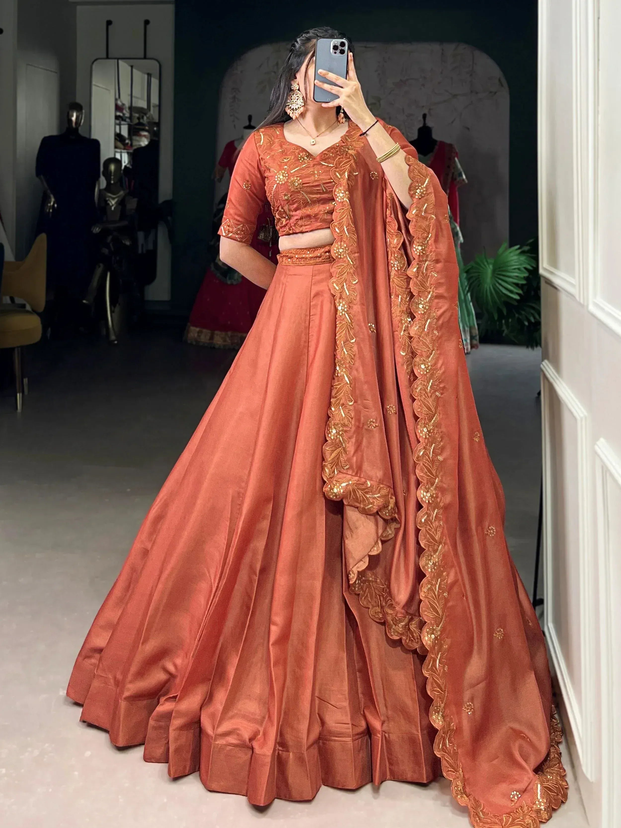 Terracotta lehenga choli with gold embroidery, perfect for Indian ethnic wear and festive occasions.