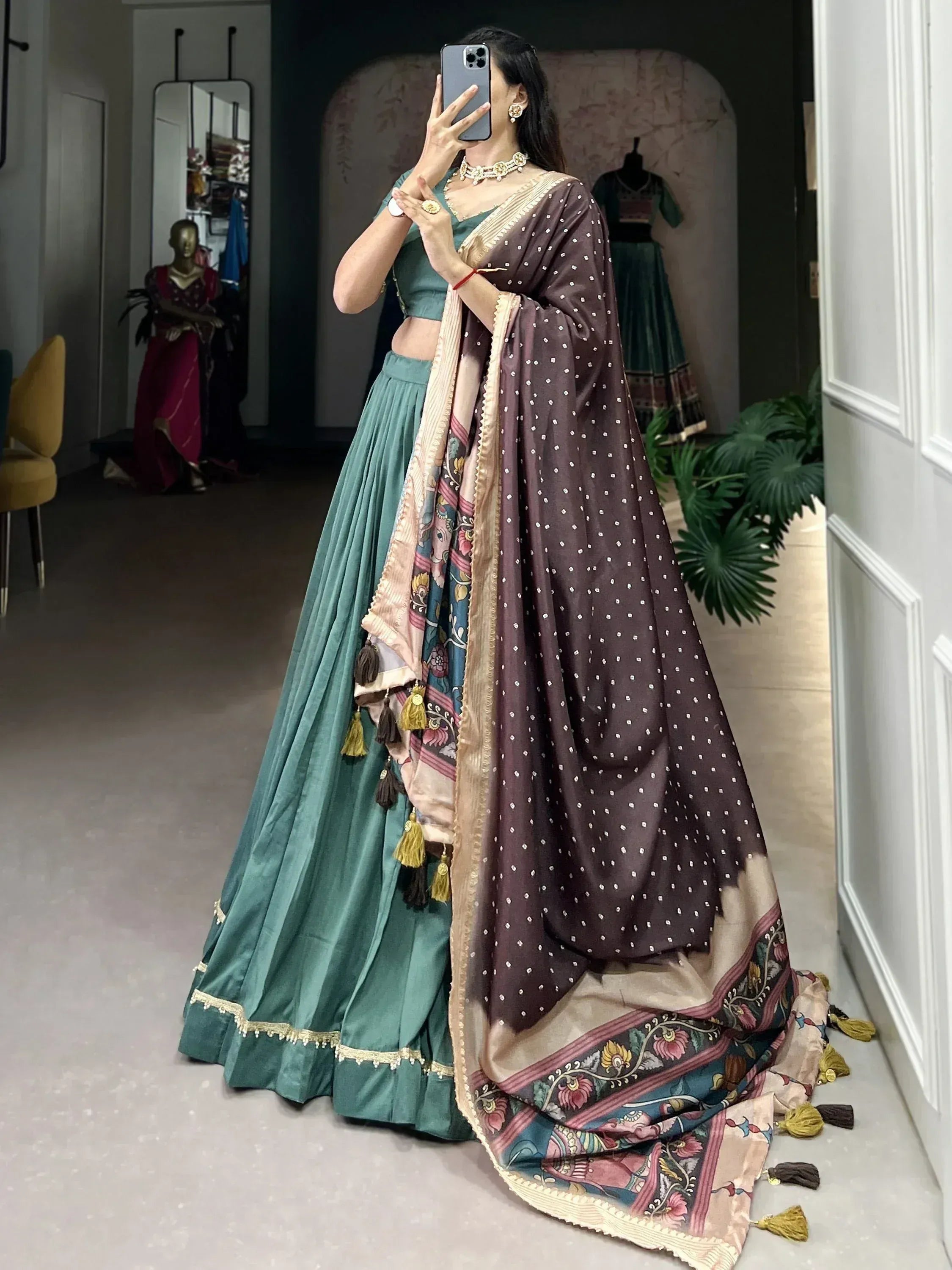 Woman in teal lehenga choli with polka dot dupatta, ethnic Indian wear for festive occasions