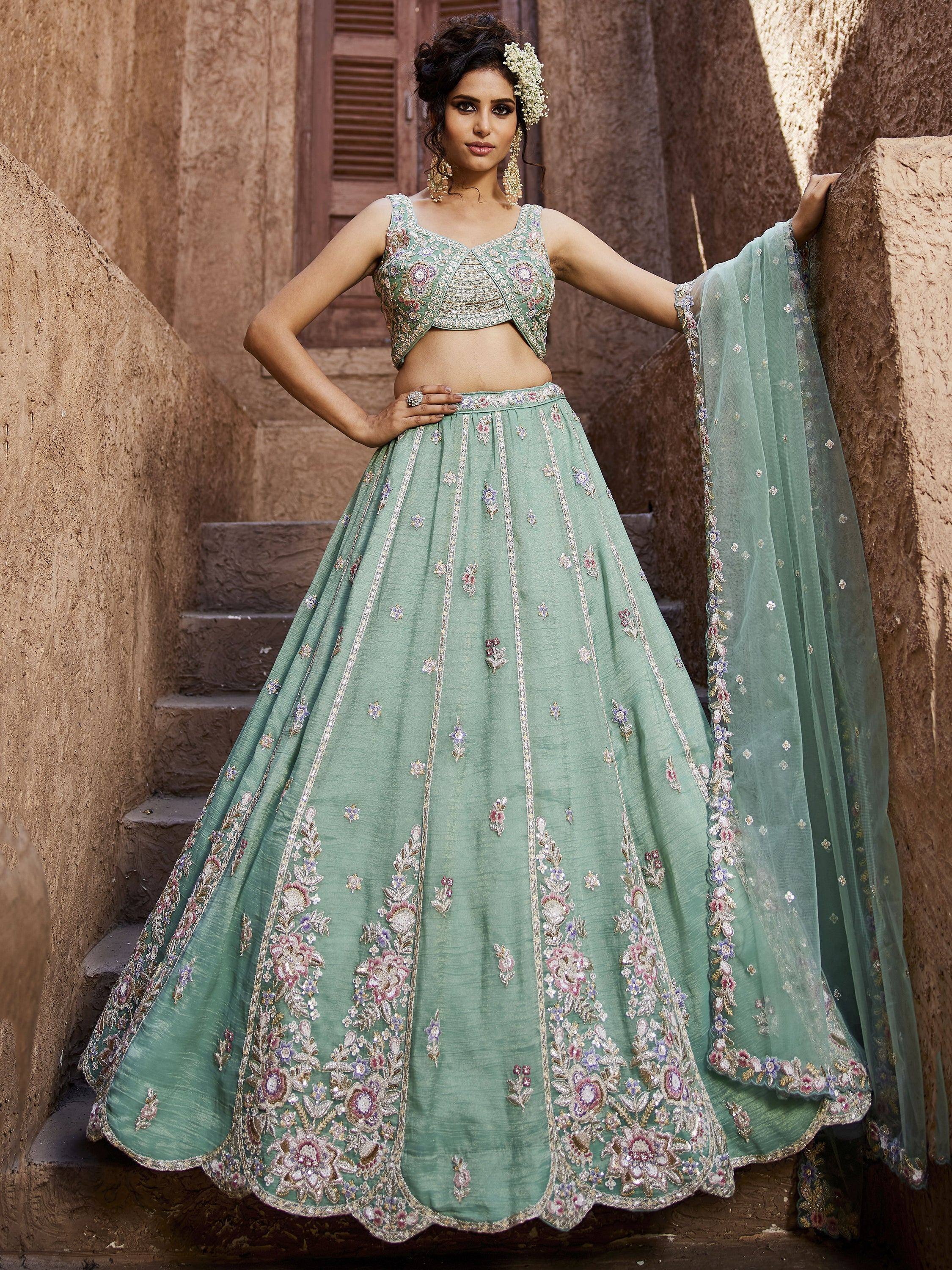 Mint green embroidered lehenga choli with floral motifs, perfect for Indian weddings and festive occasions.