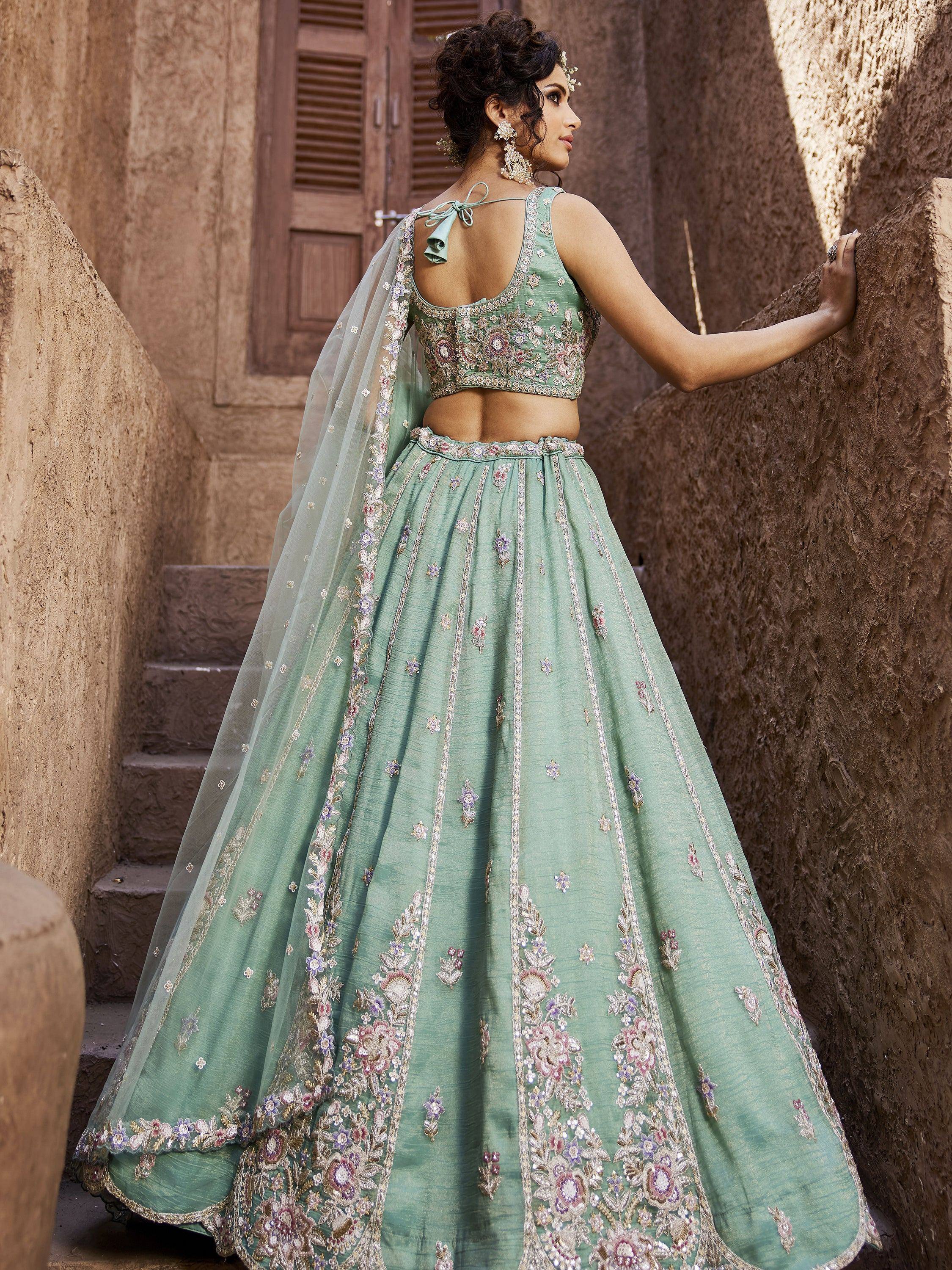 Mint green embroidered lehenga choli with floral detailing, perfect for Indian weddings and festive occasions.
