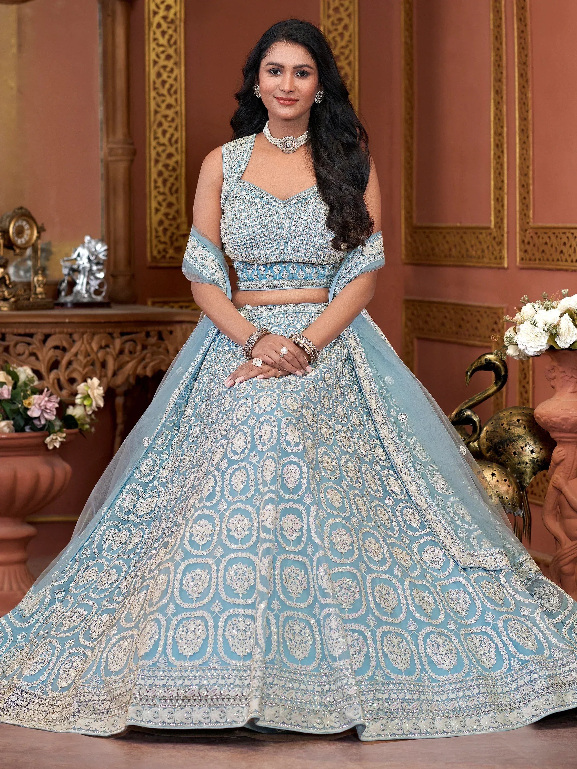 Elegant light blue designer lehenga choli with intricate silver embroidery, perfect for Indian weddings and festive occasions.