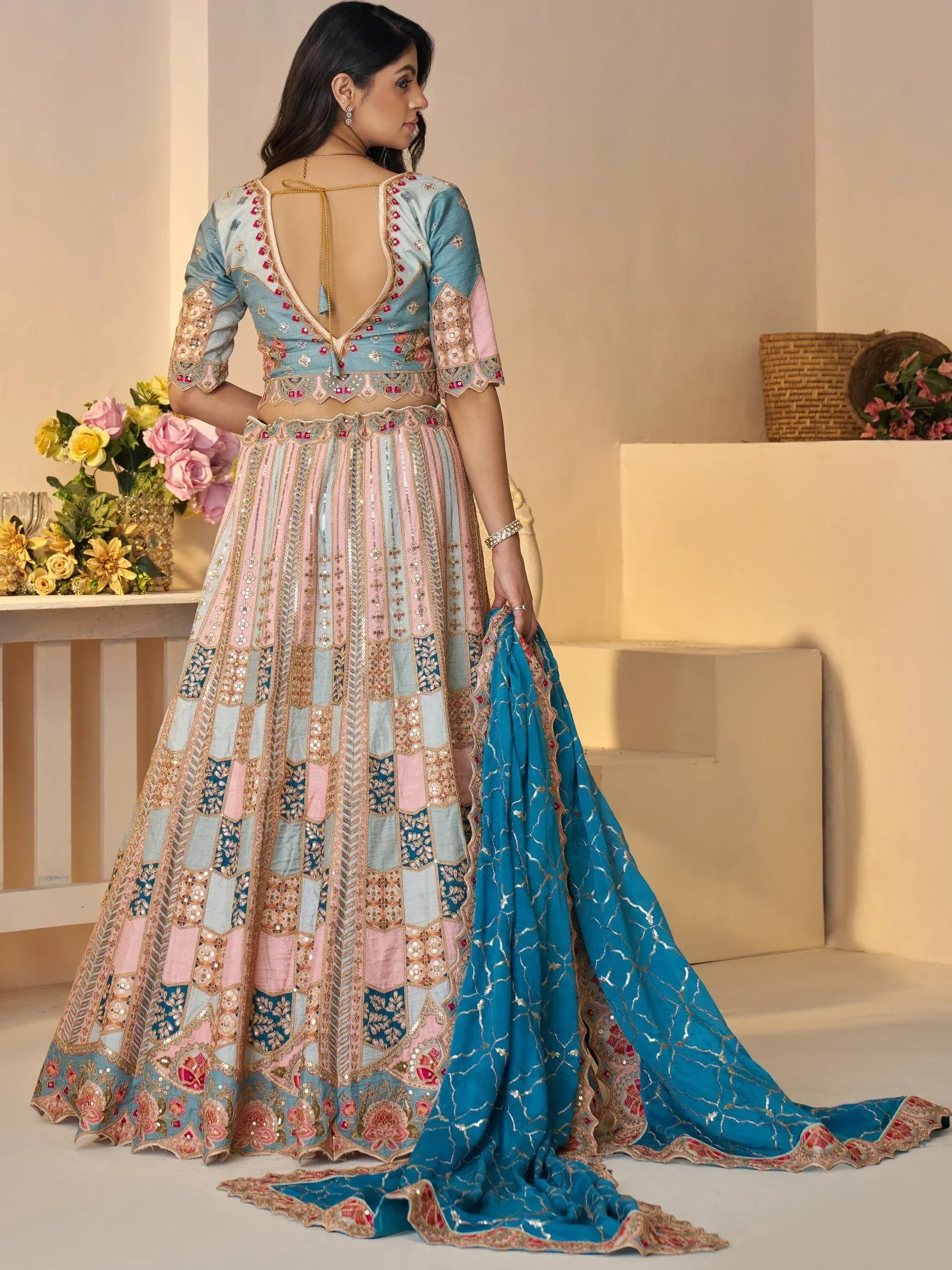 Designer lehenga choli with pastel patchwork, floral embroidery, and backless blouse for Indian ethnic wear