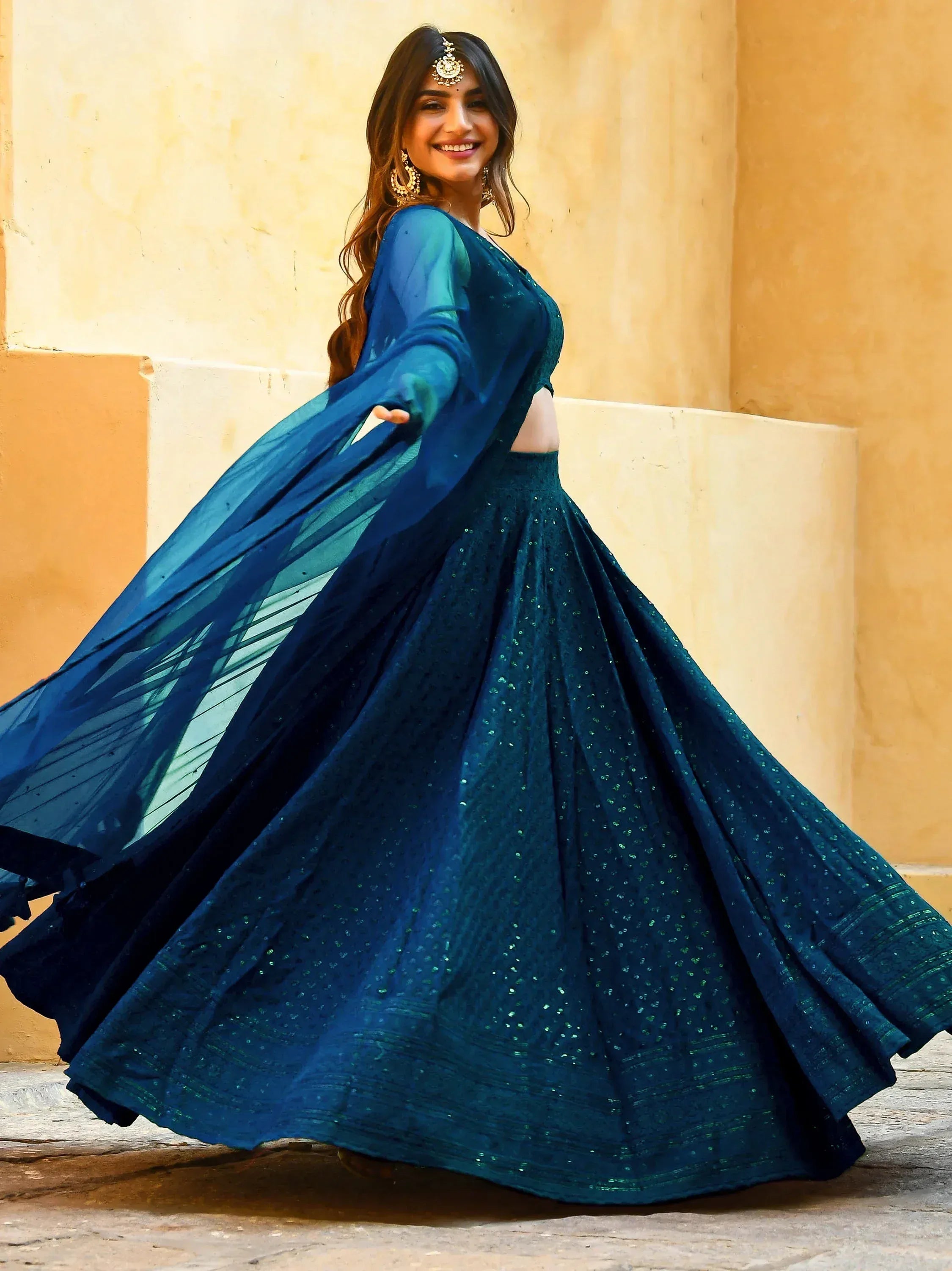Woman in elegant blue lehenga choli with sheer dupatta, perfect for Indian ethnic occasions