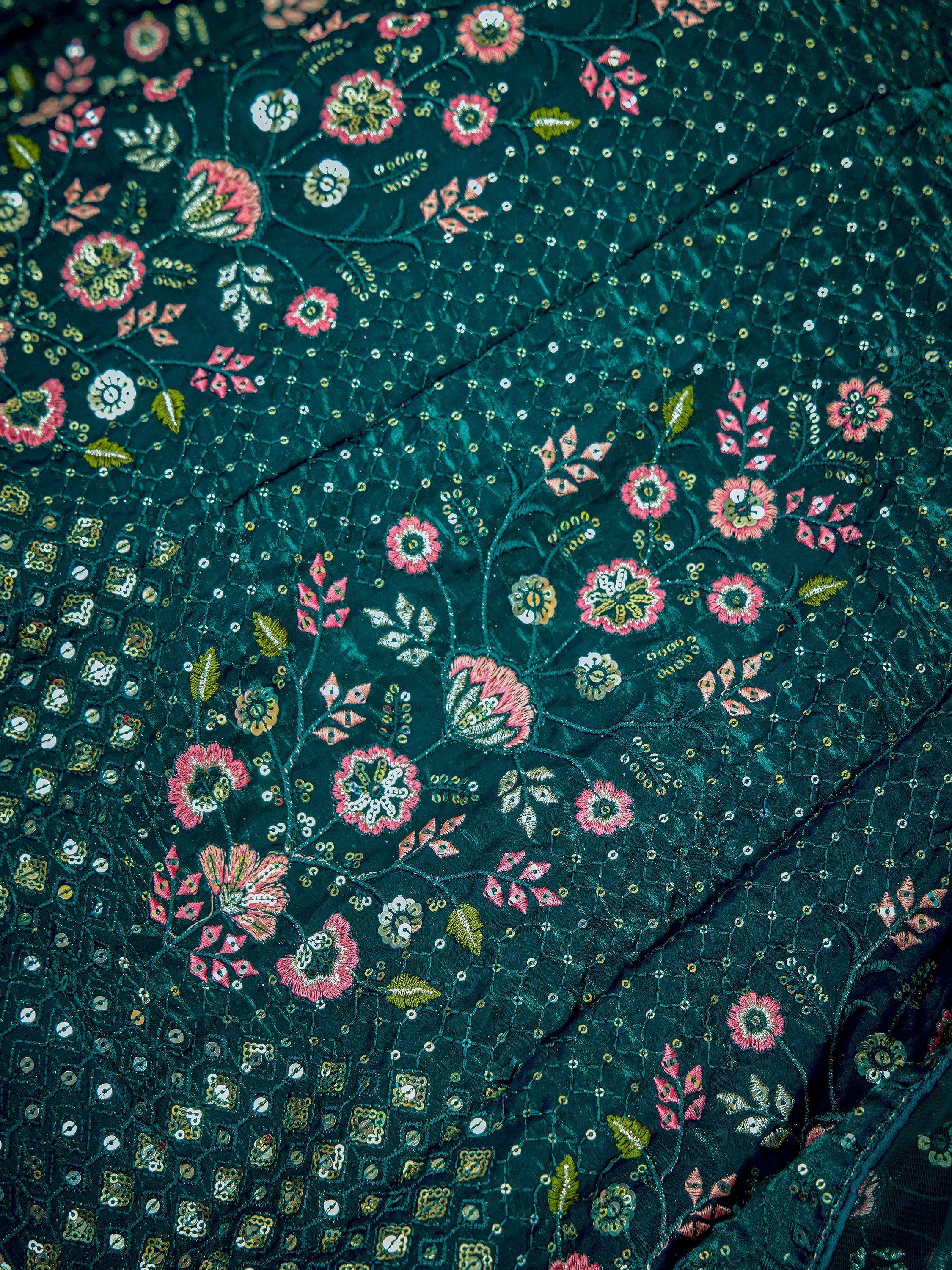 Teal ethnic wear fabric with pink floral embroidery and gold sequin detailing for lehenga or saree