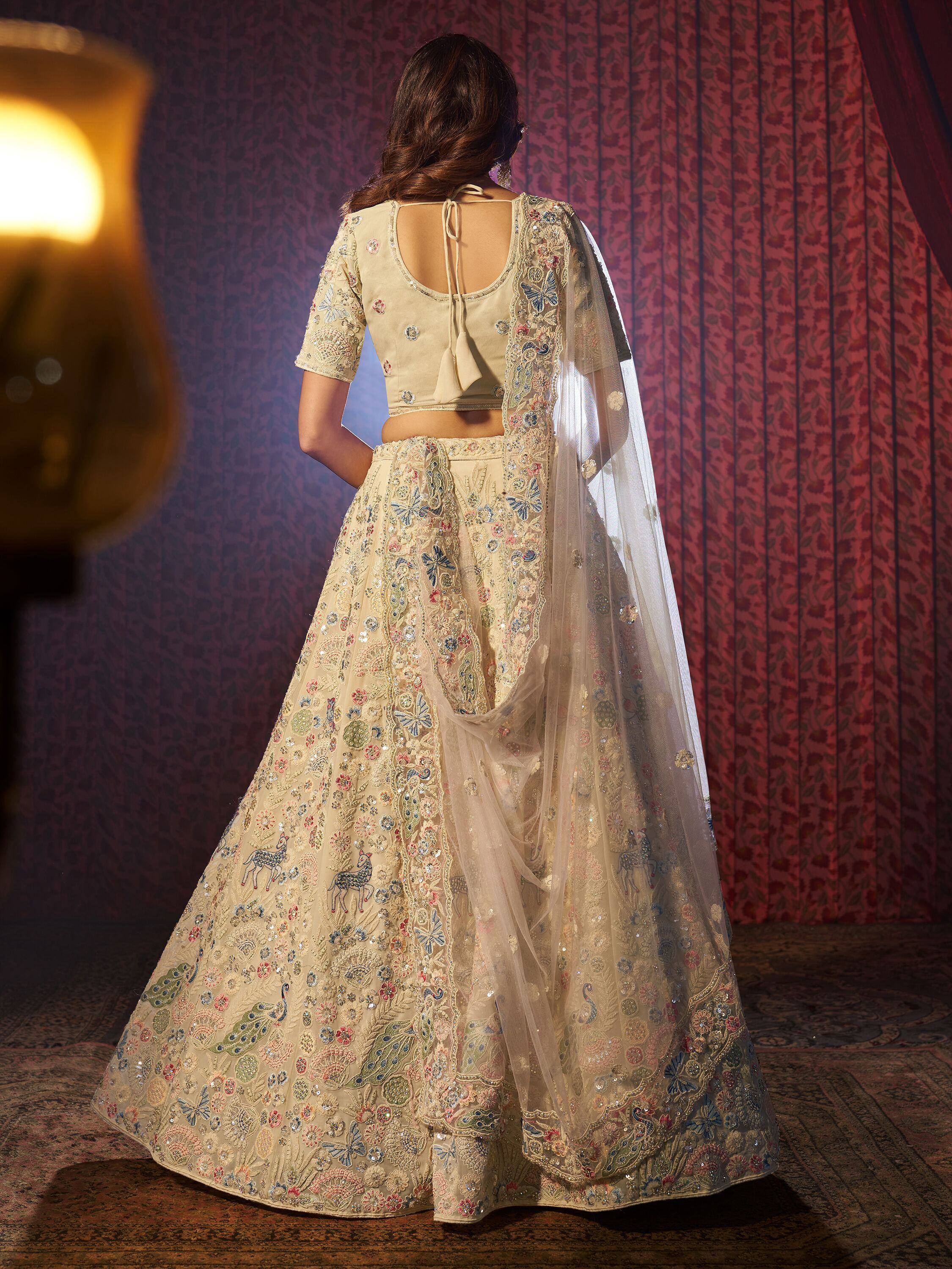 Beige embroidered lehenga choli with floral and peacock motifs, sheer dupatta, back view