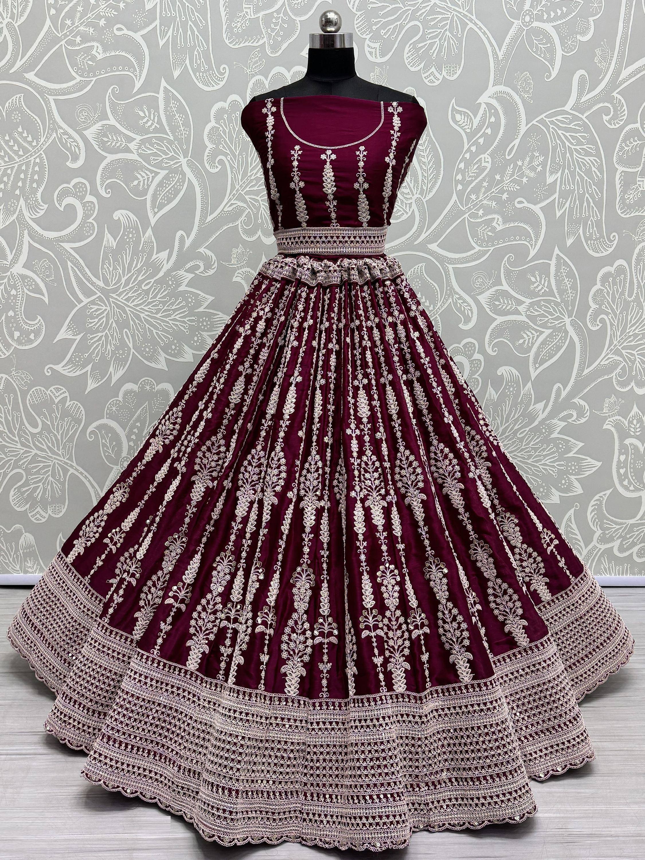 Maroon designer lehenga choli with intricate white embroidery, perfect for Indian ethnic wear occasions.