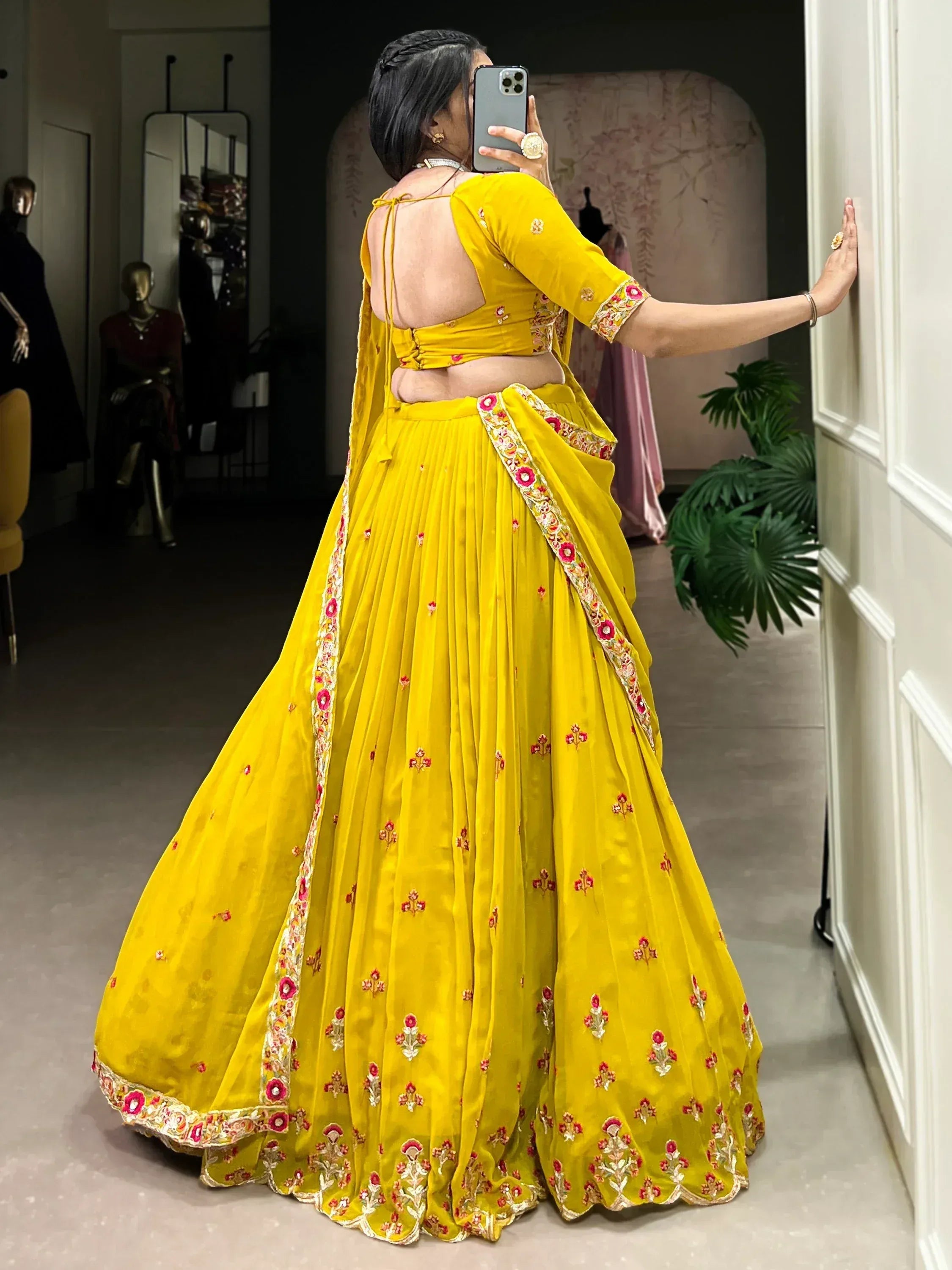 Yellow embroidered lehenga choli with floral detailing, backless blouse, perfect for Indian ethnic wear